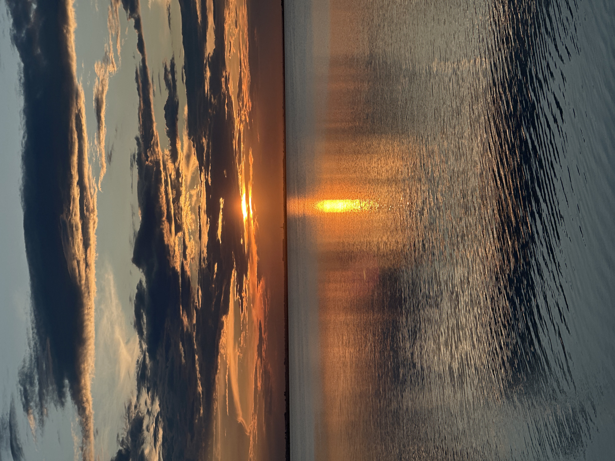 Sunset sailboat scene captured over Kokshetau lake waters