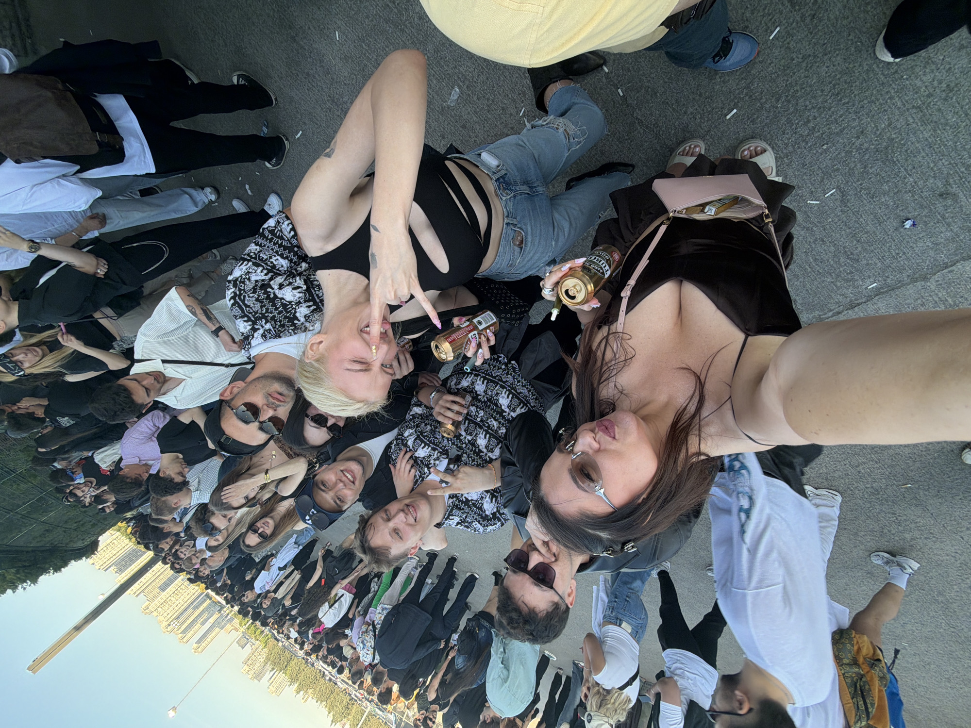 Women with beer cans photographed at crowd gathering in Başakşehir
