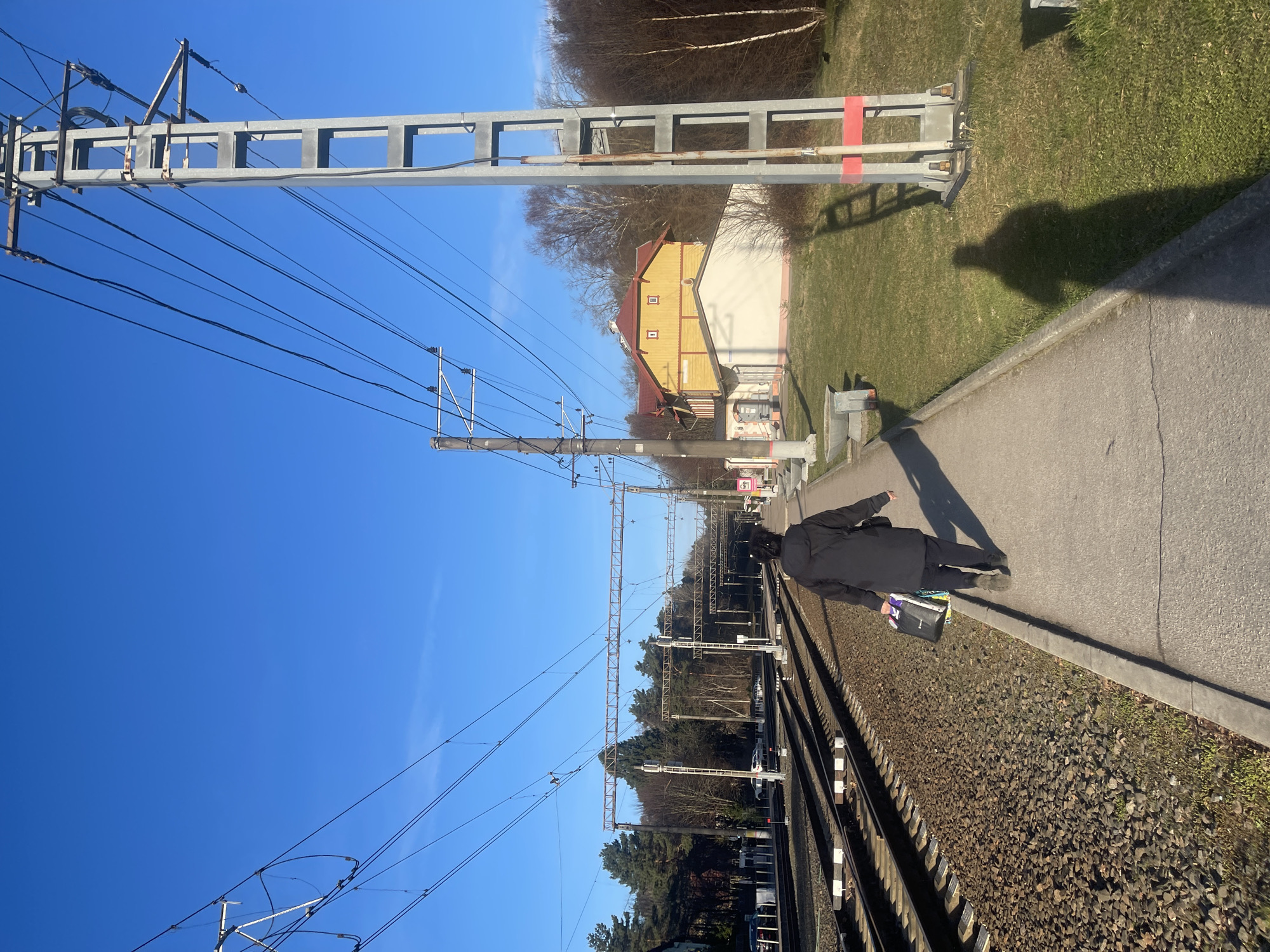 Traveler with bags waits on railway platform in Svetlogorsk