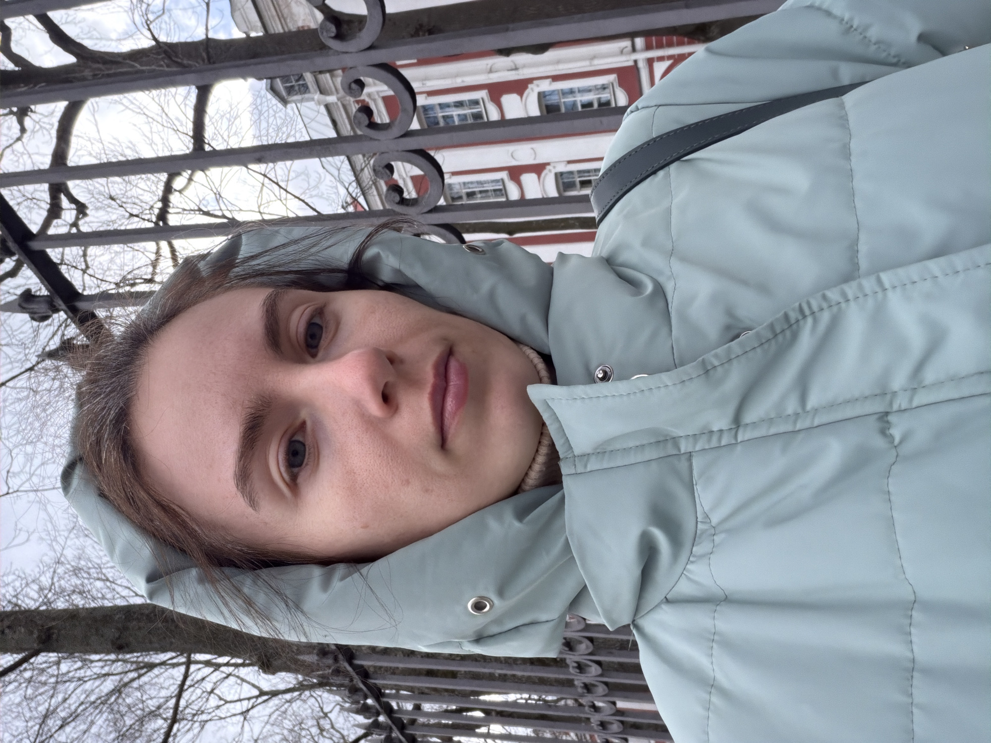 Woman in blue jacket spotted near fence in Saint Petersburg