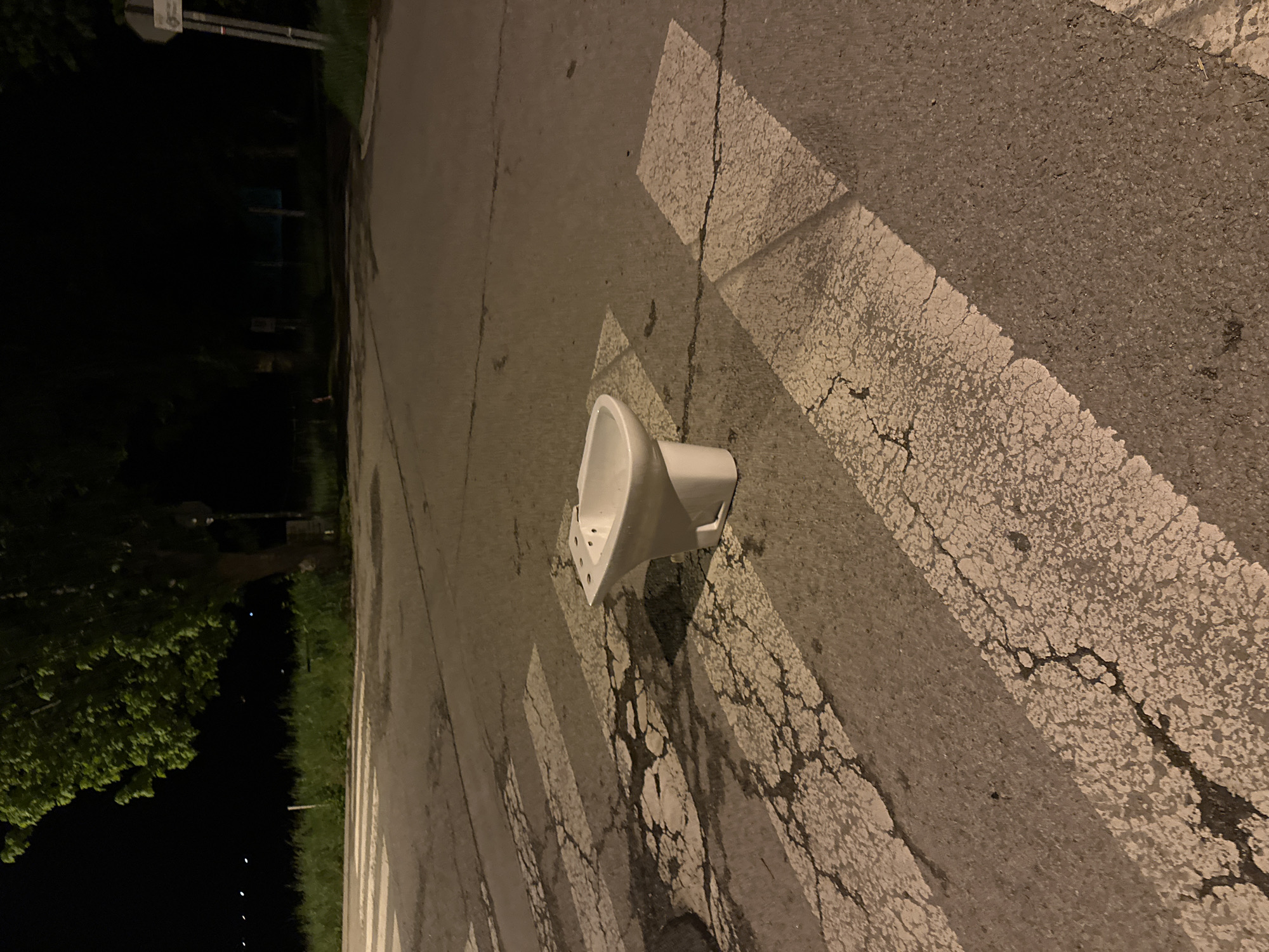 Ceramic urinal found abandoned on crosswalk