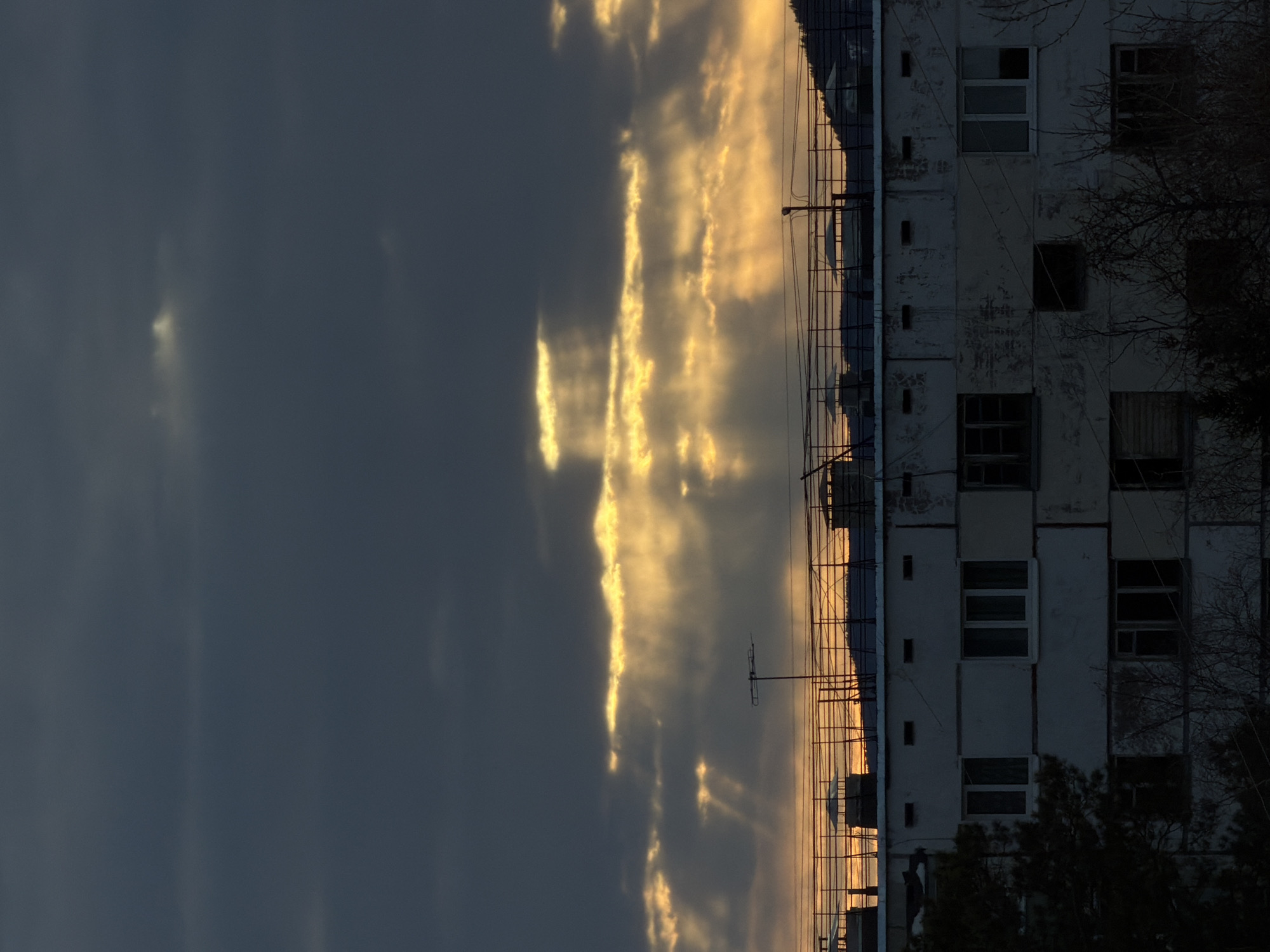 Sunlight breaks through clouds over Ust-Ilimsk apartment building