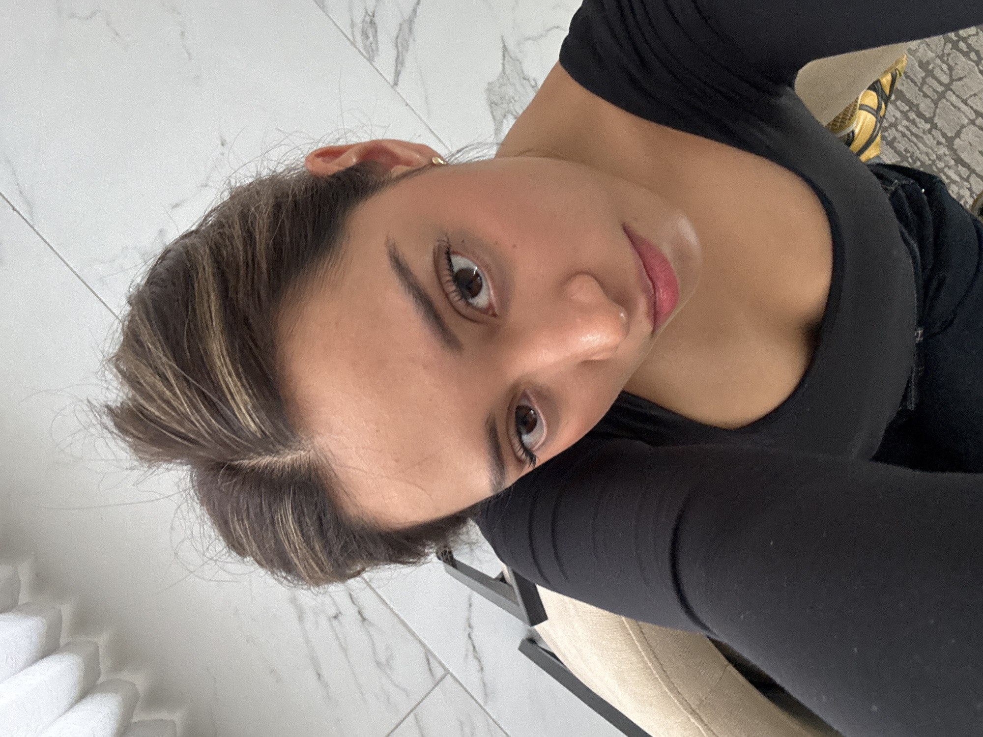 Woman takes selfies at Hotel Cartesiano lobby in Puebla