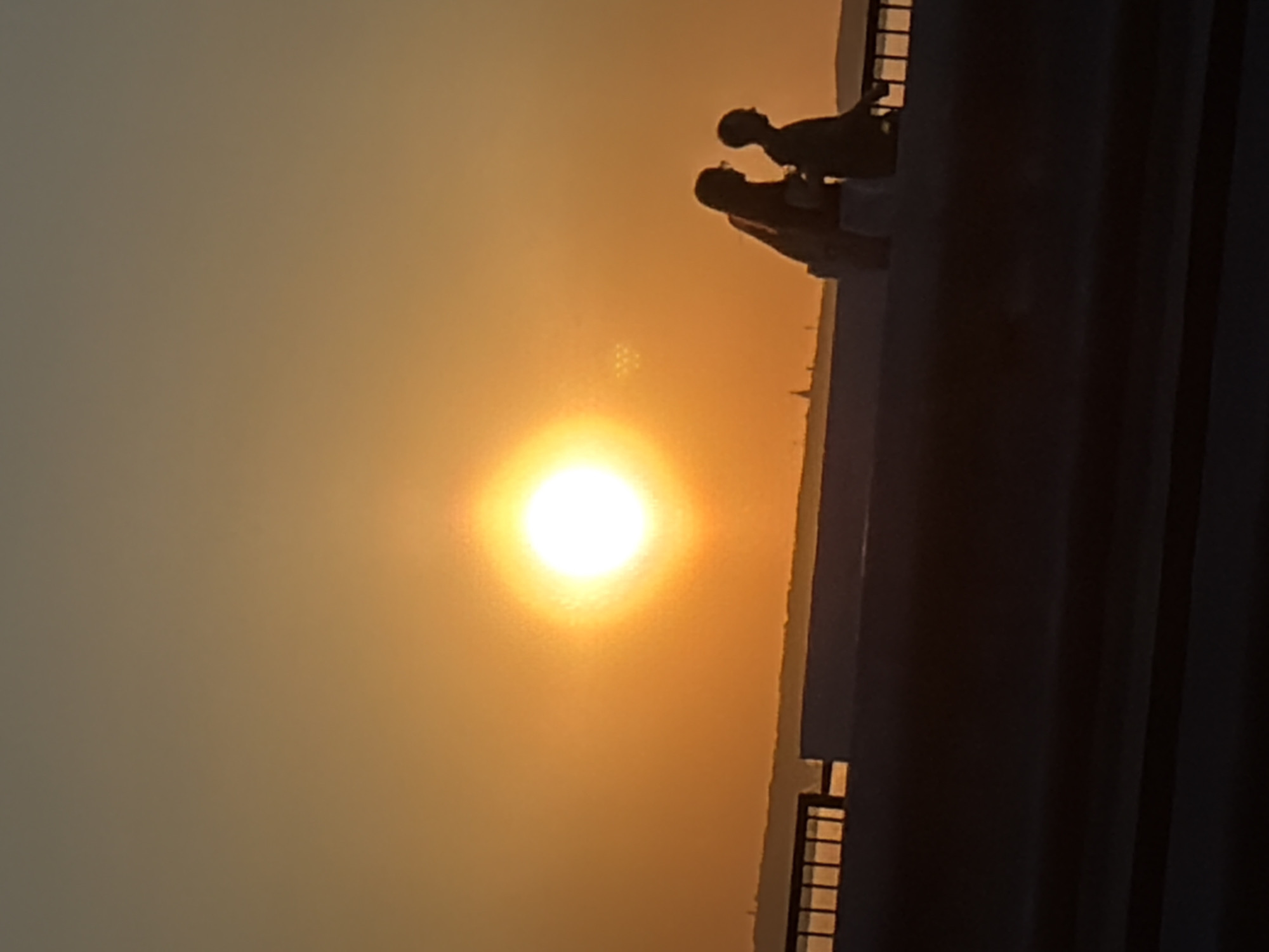 Two figures silhouetted against sunset in Izhevsk, Russia