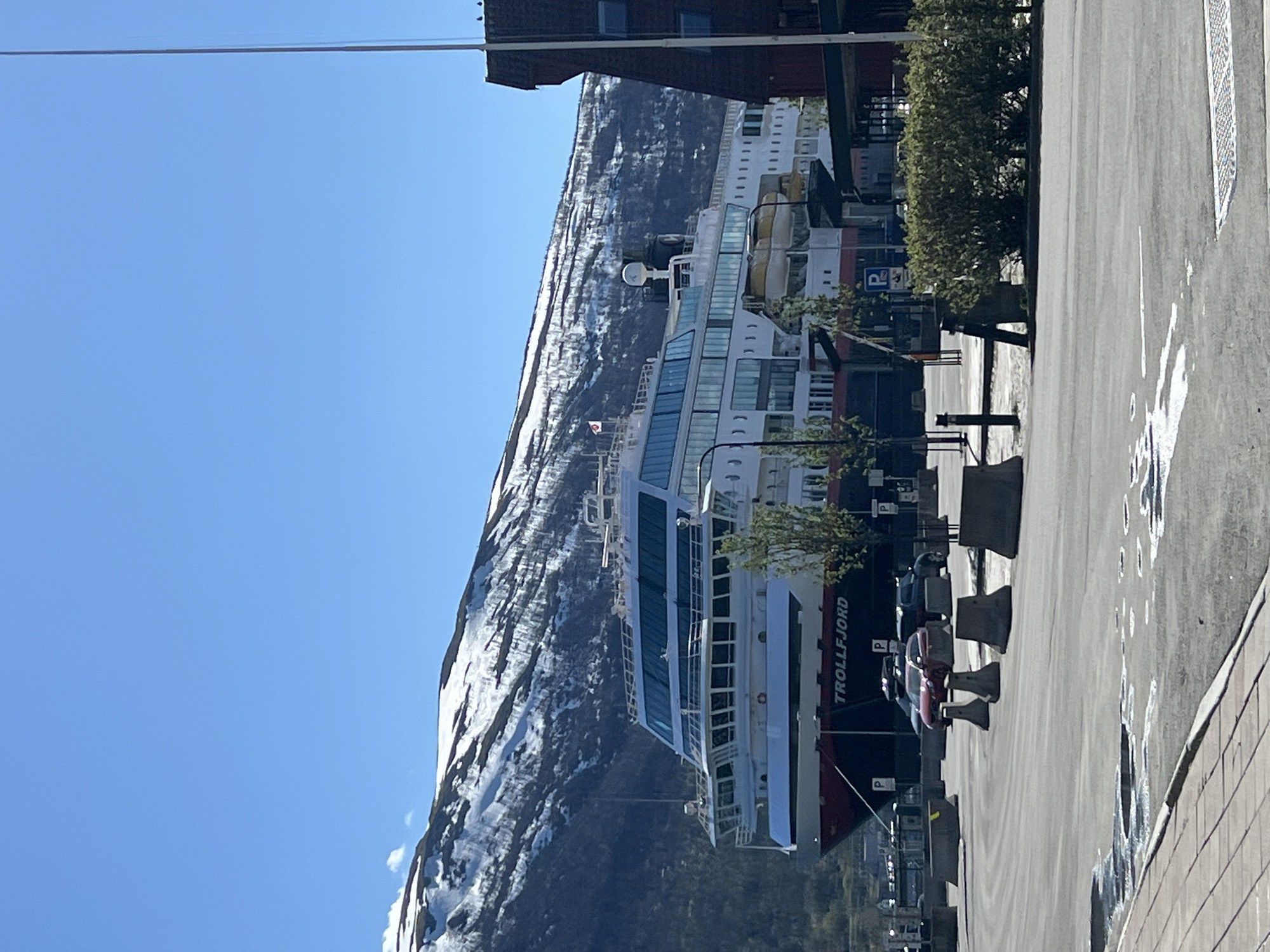 Cruise ship Trollfjord docks in Tromsø amid snowy mountains