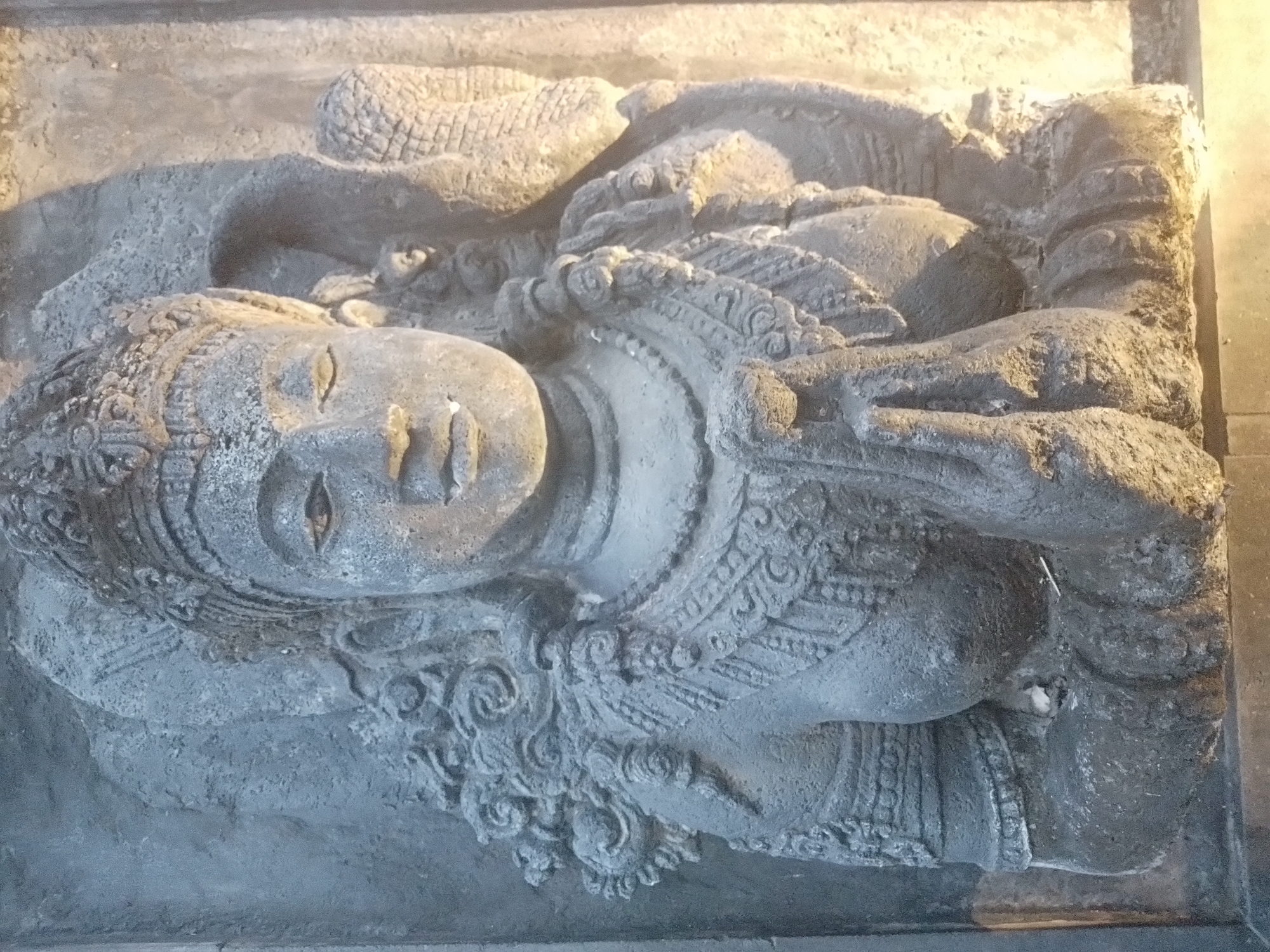 Ornate relief sculpture of reclining figure observed in North Kuta