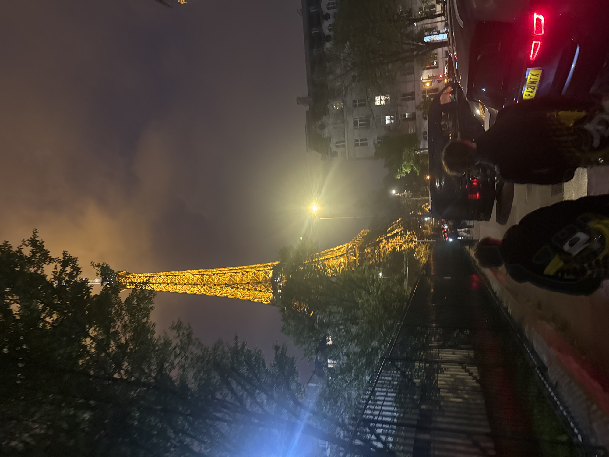 Eiffel Tower glows yellow in evening Paris scene