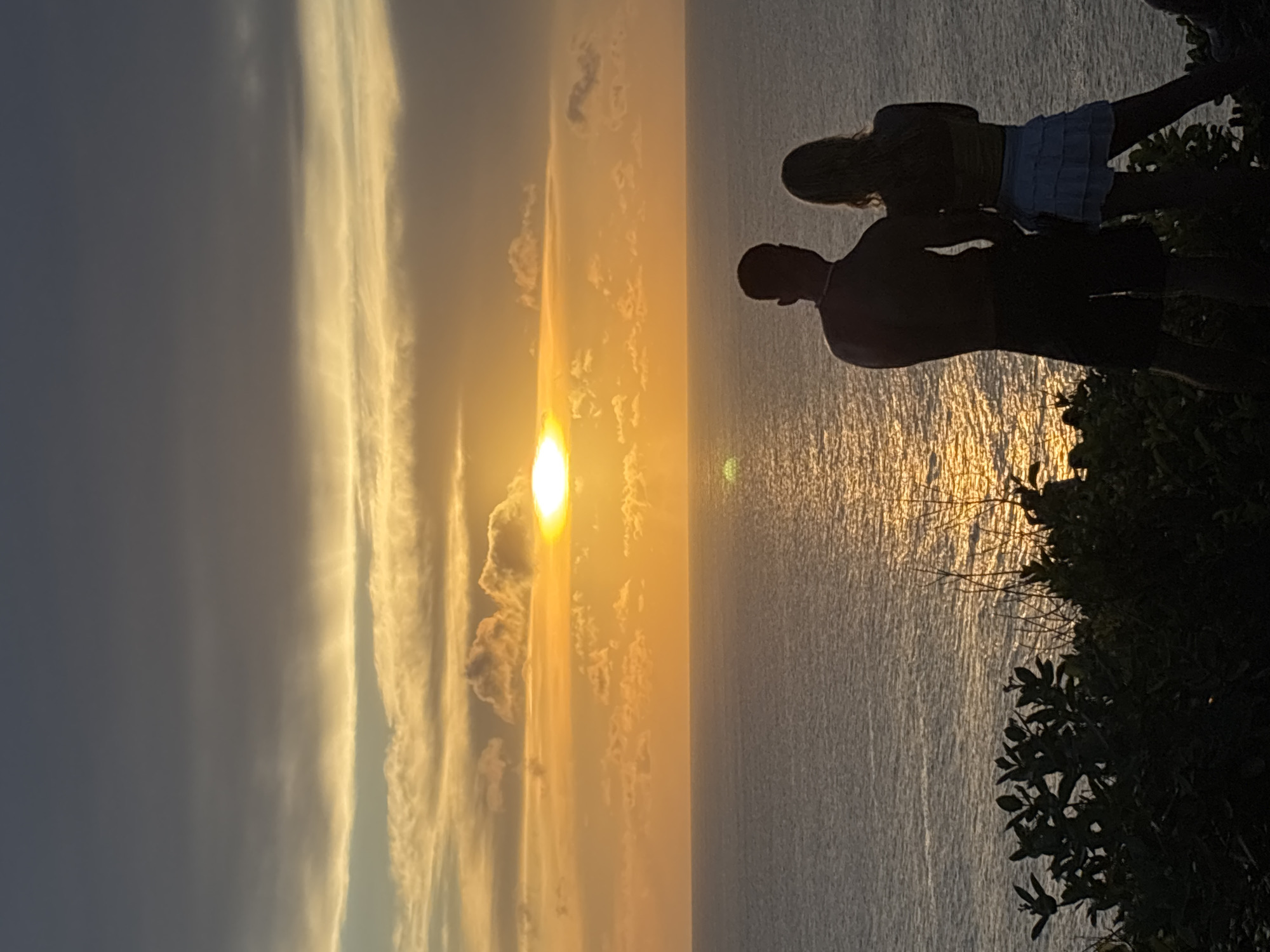 Sunset viewed through clouds over Uluwatu ocean waters