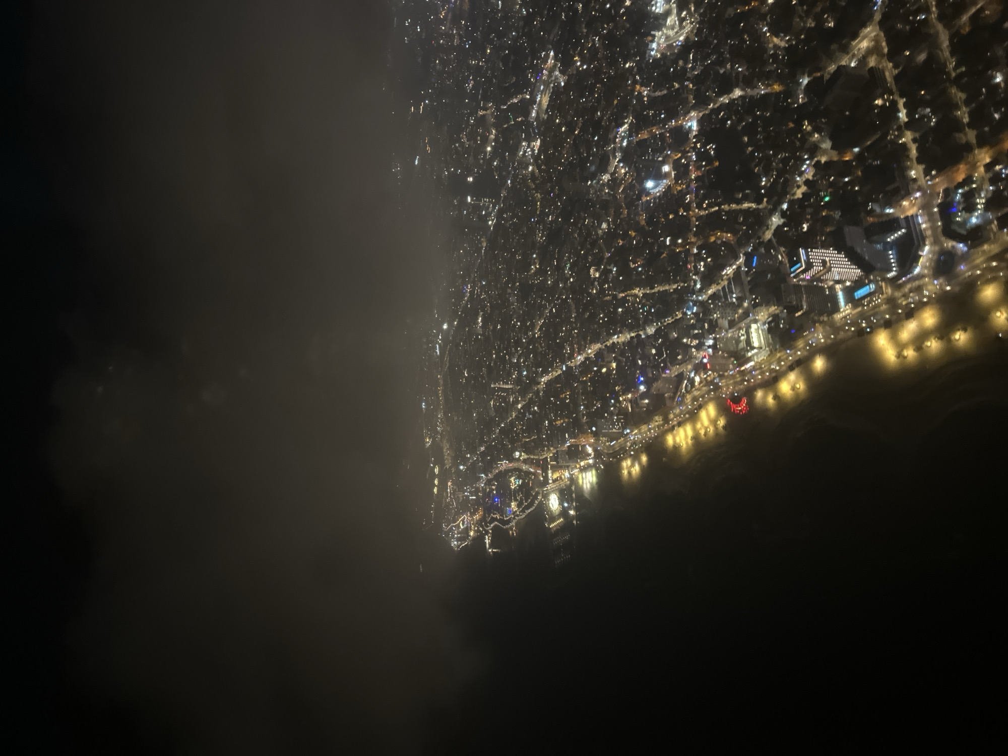 Nighttime aerial view captures illuminated Tel Aviv coastline