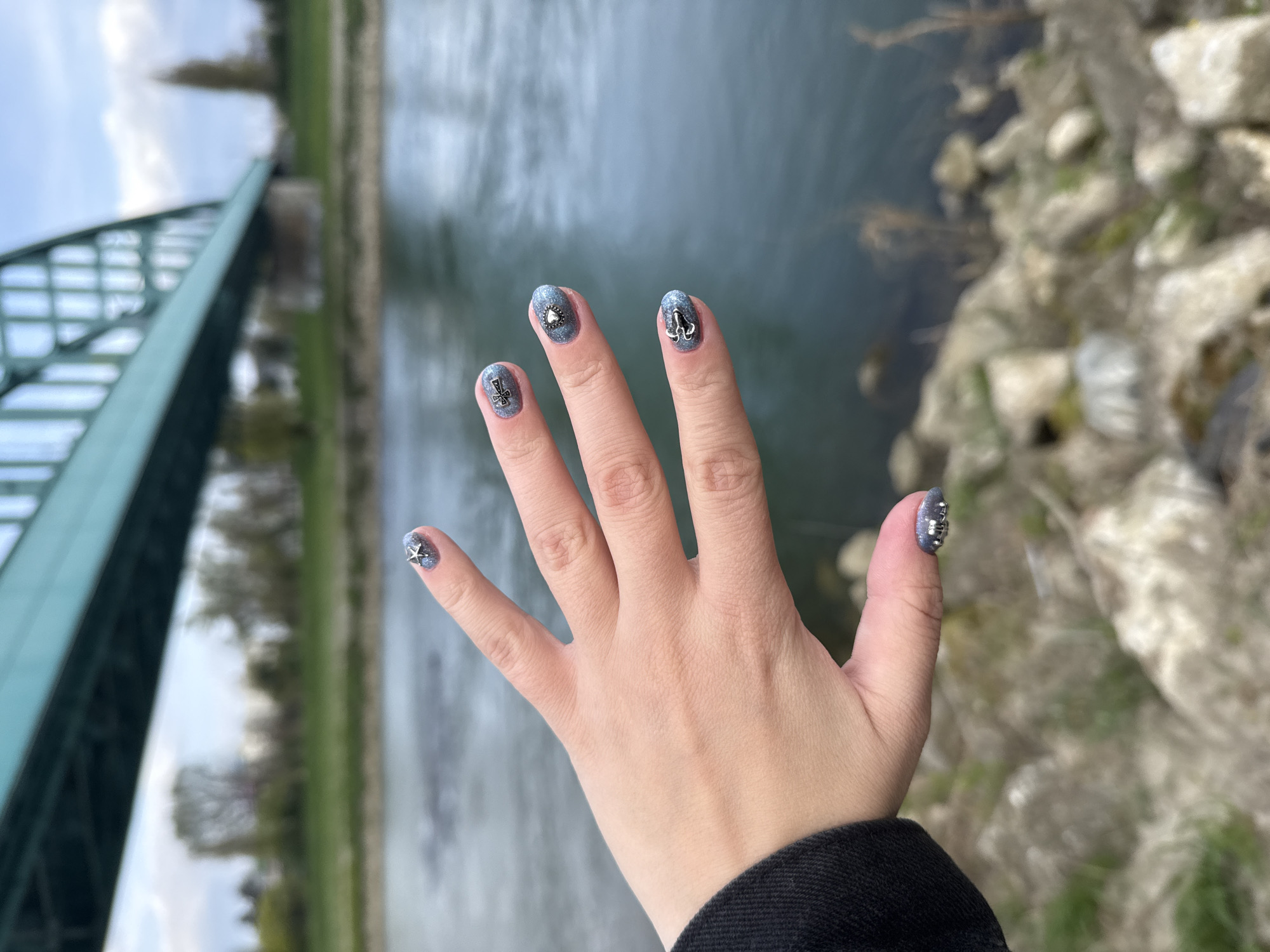 Person with colorful hair takes selfies by Zagreb bridge