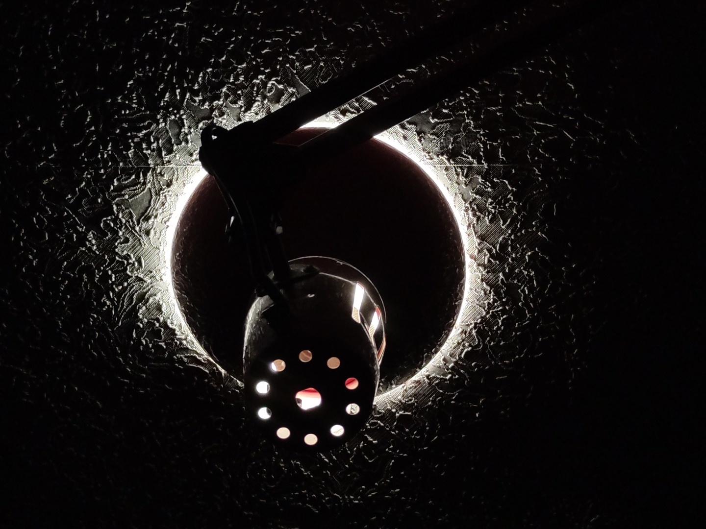 Low-angle detail shot of a perforated metal light fixture