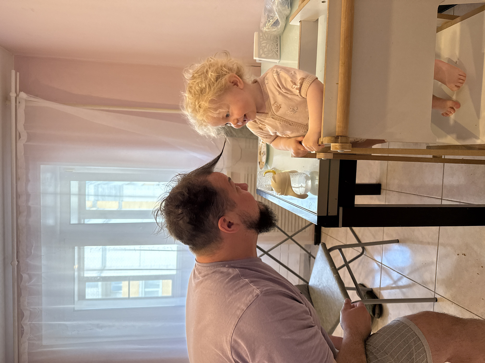 Adult and toddler interact at playground in Vladimir