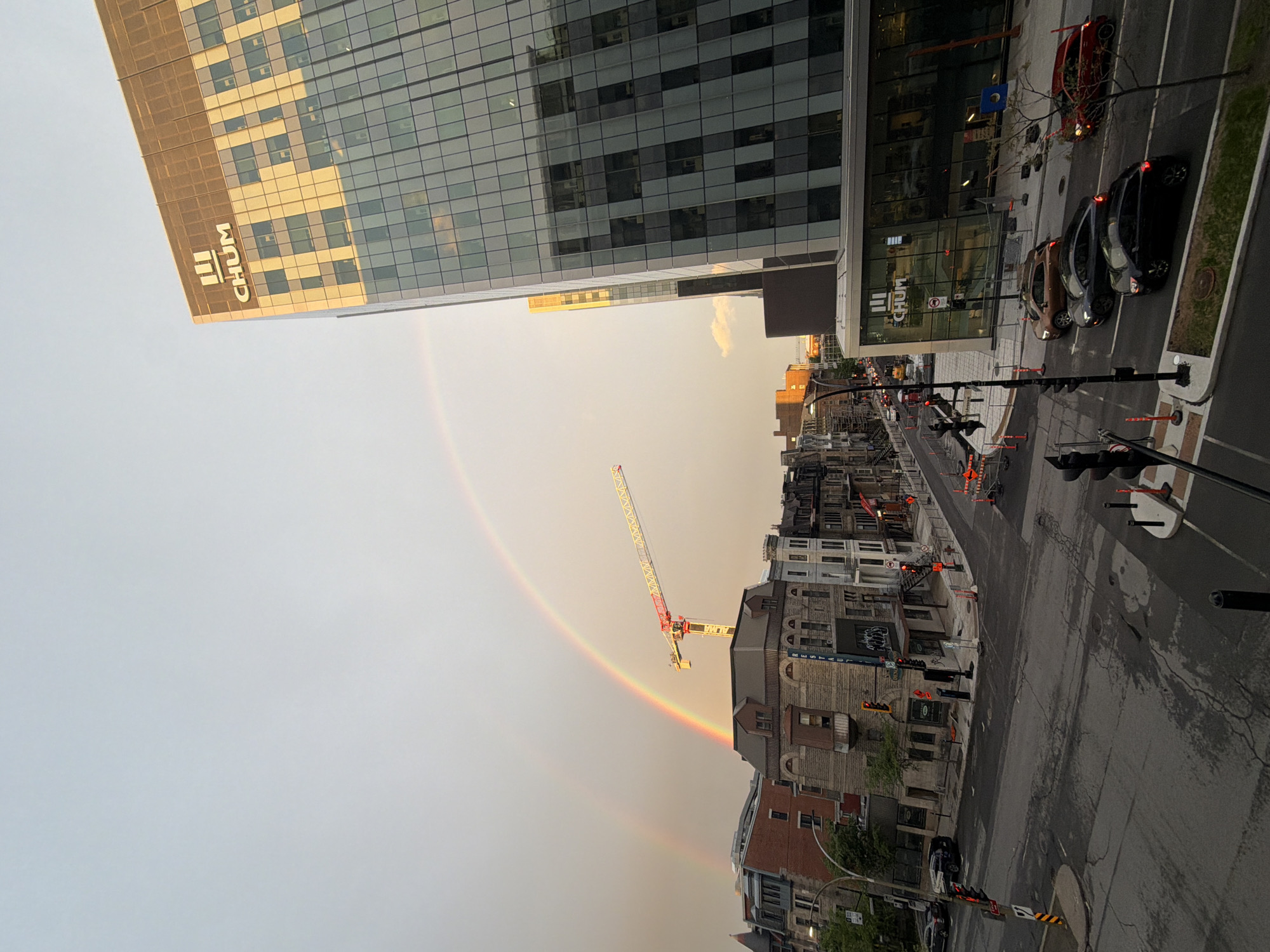 Rainbow appears over downtown Montreal construction site after midnight