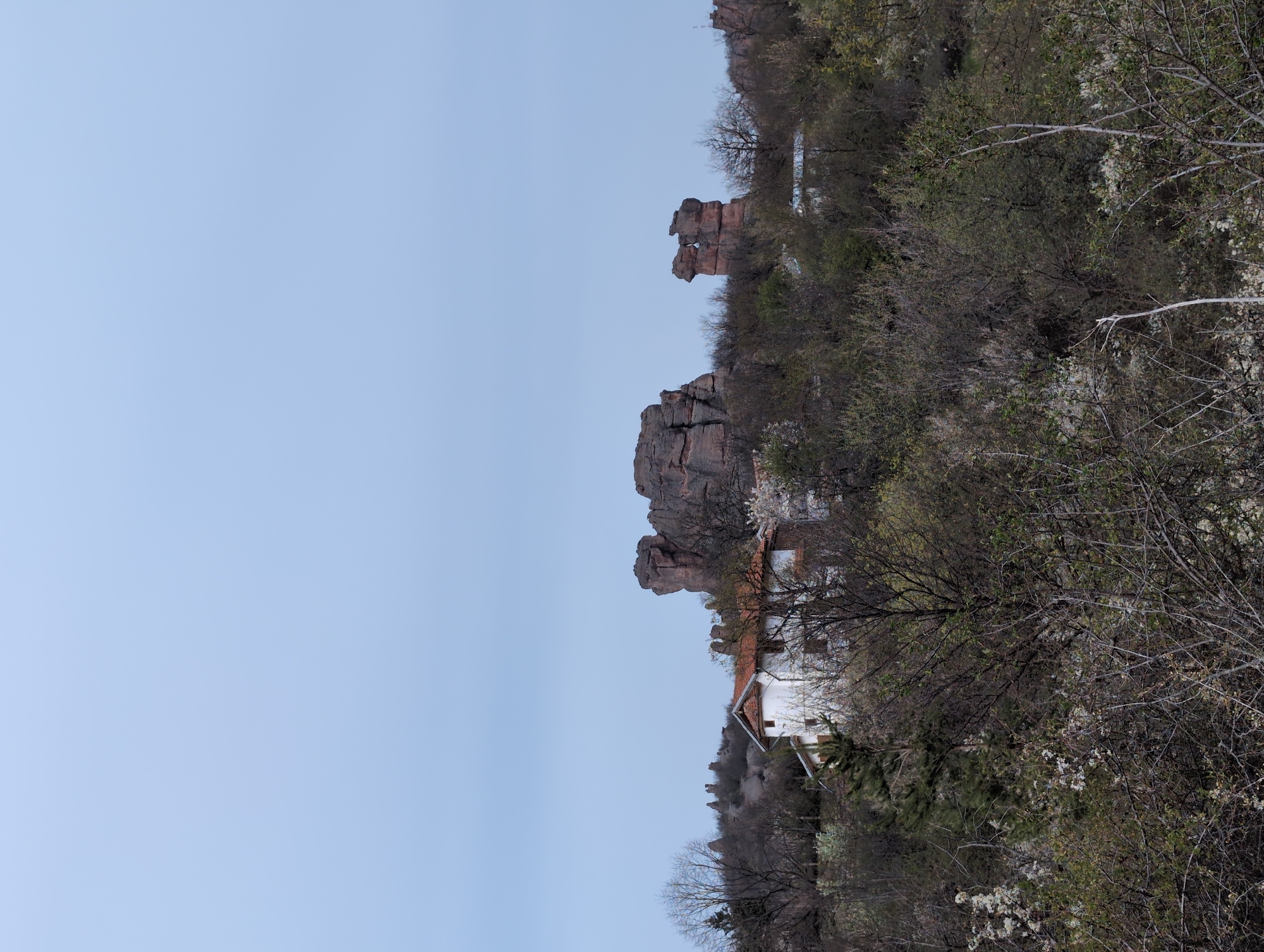 Witness documents rocky landscape with white building in Chiflik, Bulgaria