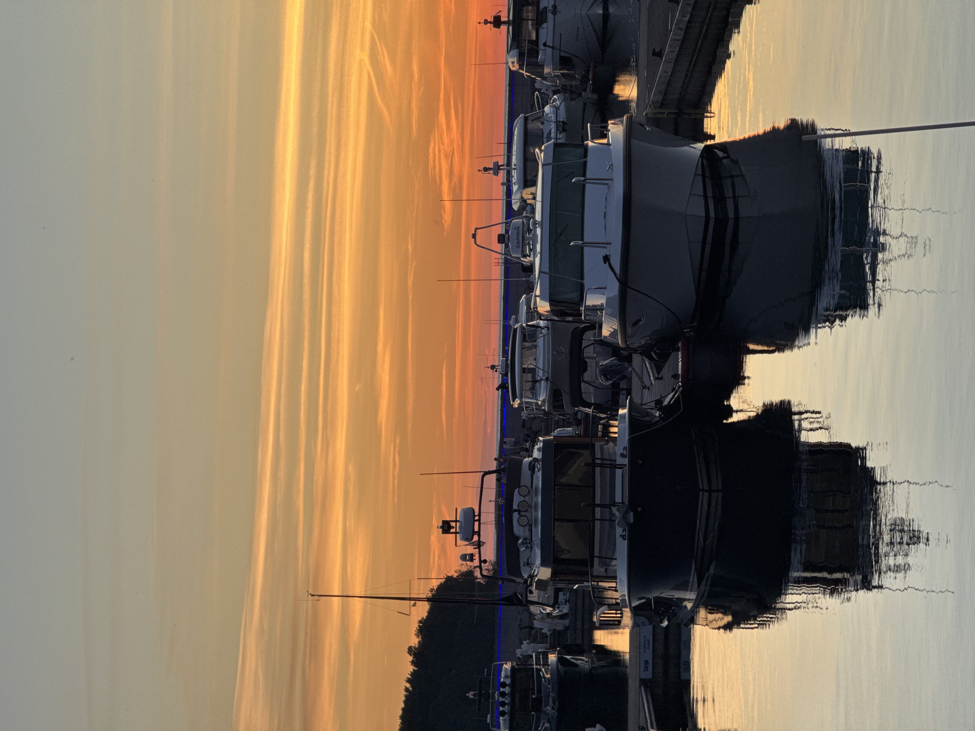 Tallinn marina at sunset, boats and walkers on a June evening