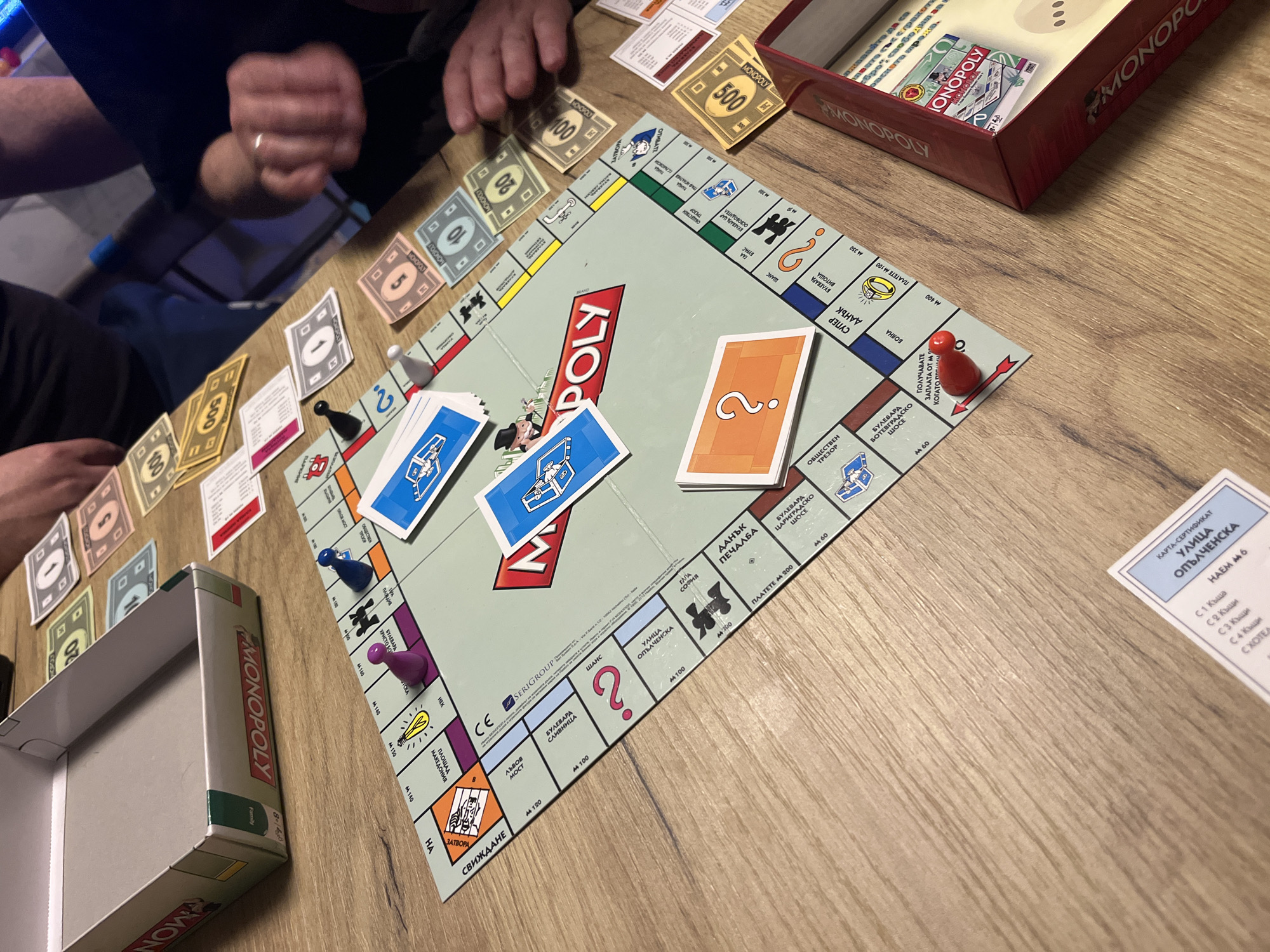 Friends toast with beer during Monopoly game in Bulgaria