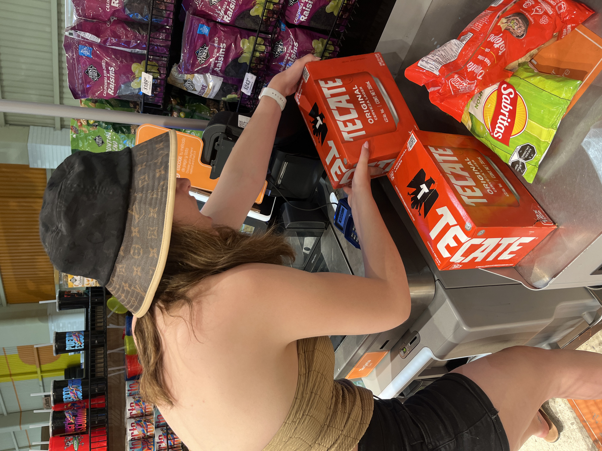 Woman purchases beer at Puerto Escondido grocery store