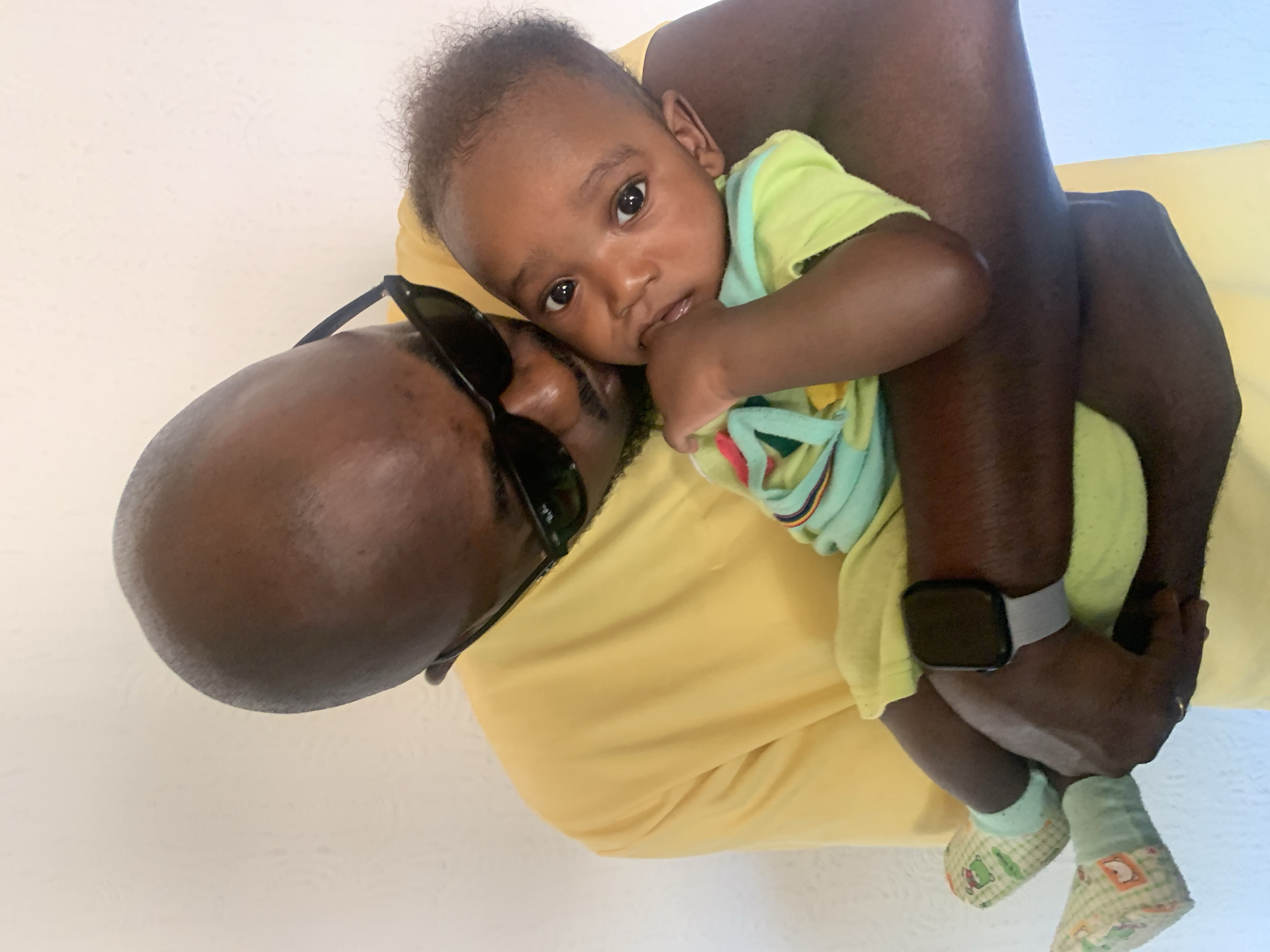 Man holds baby in intimate moment, Barakin Akawo, Nigeria