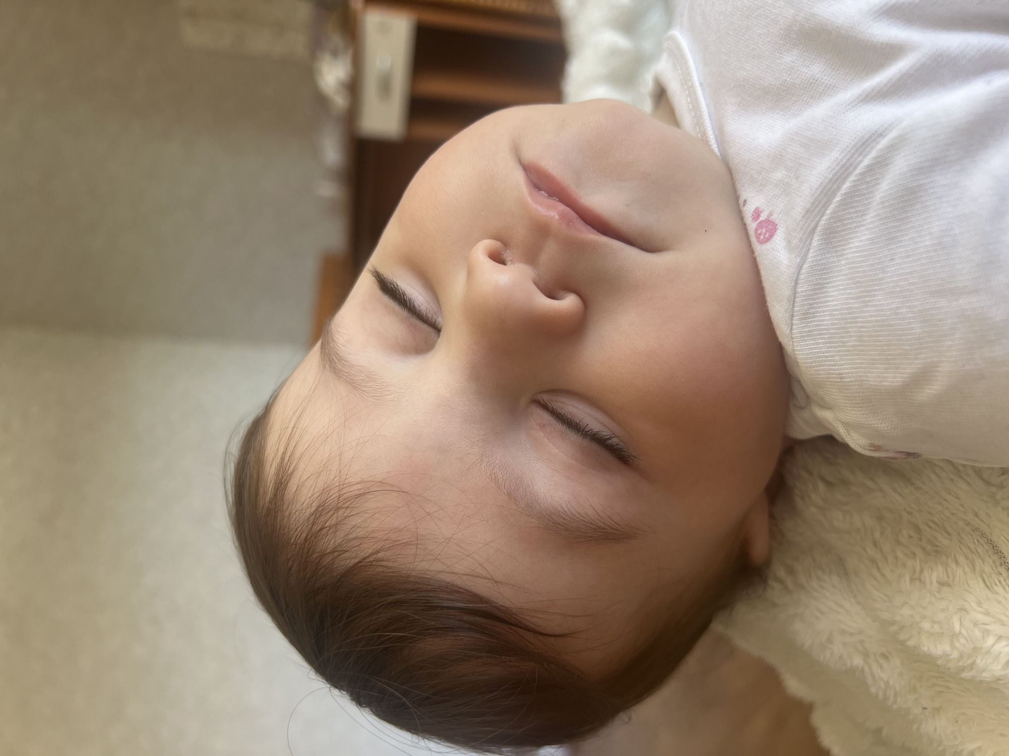 Baby in white towel photographed during care routine in Elena