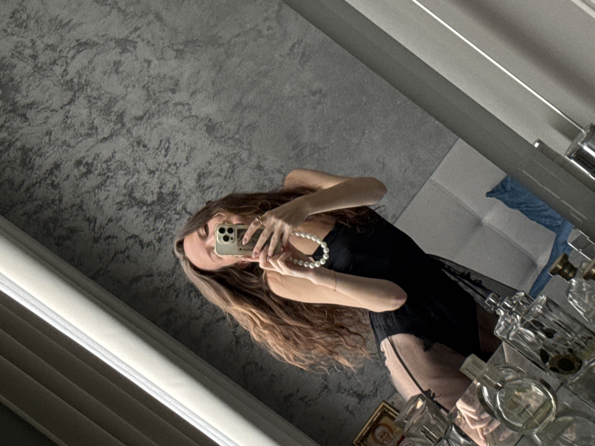 Woman takes bathroom selfies in black robe, towel