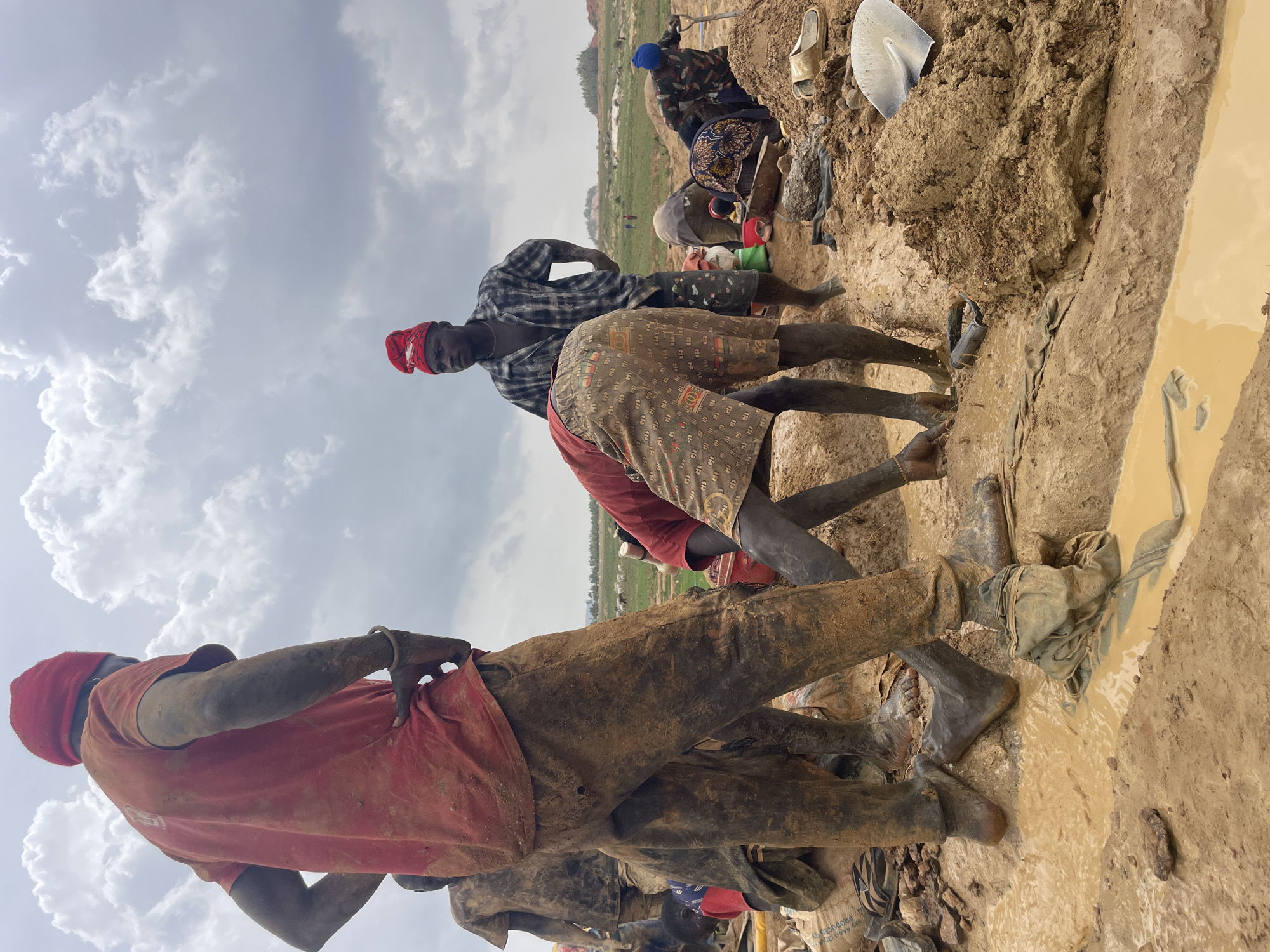 Workers conduct muddy mining operations in Maiyanga, Nigeria