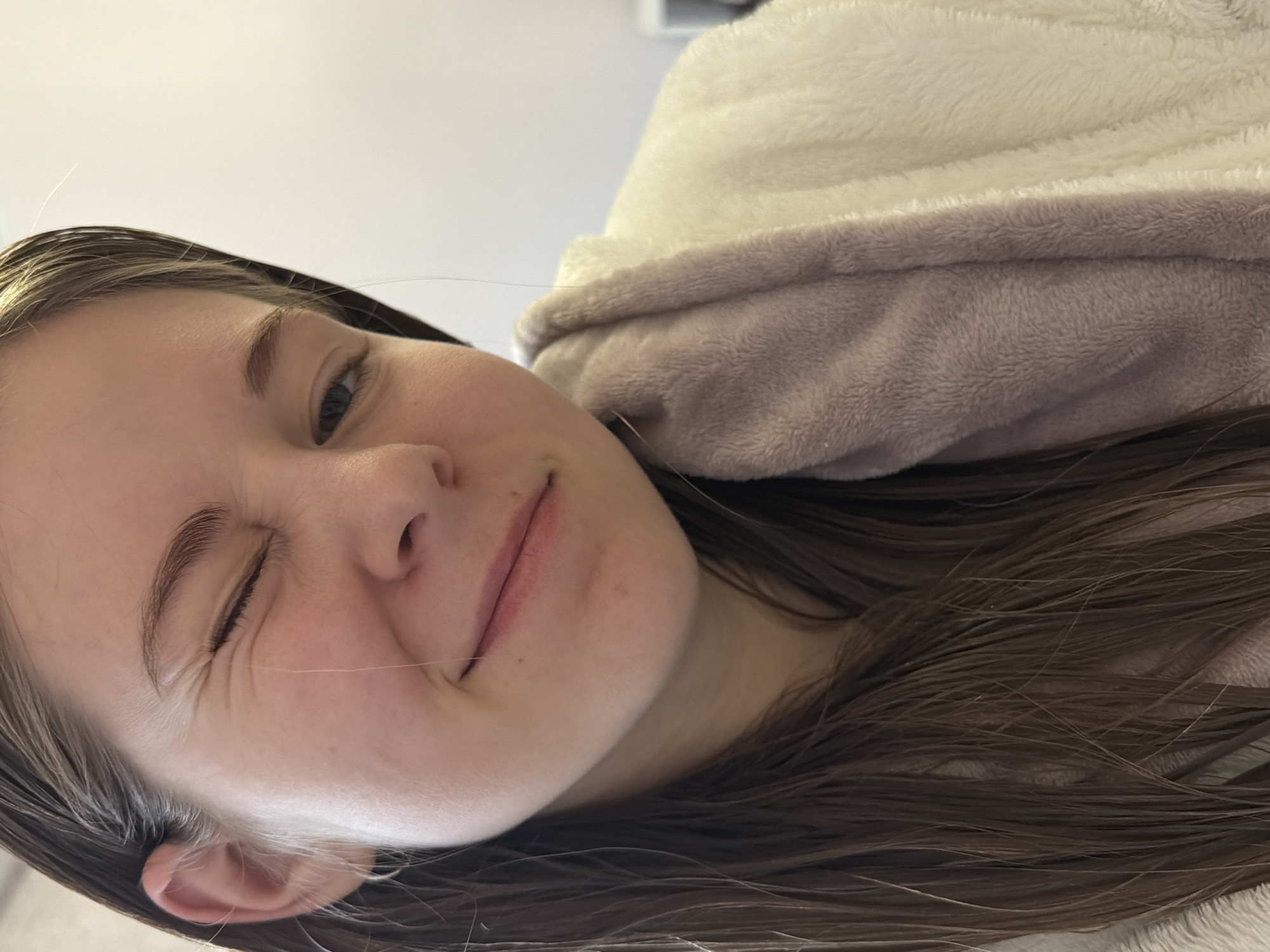 Young person documents skincare routine in selfie session
