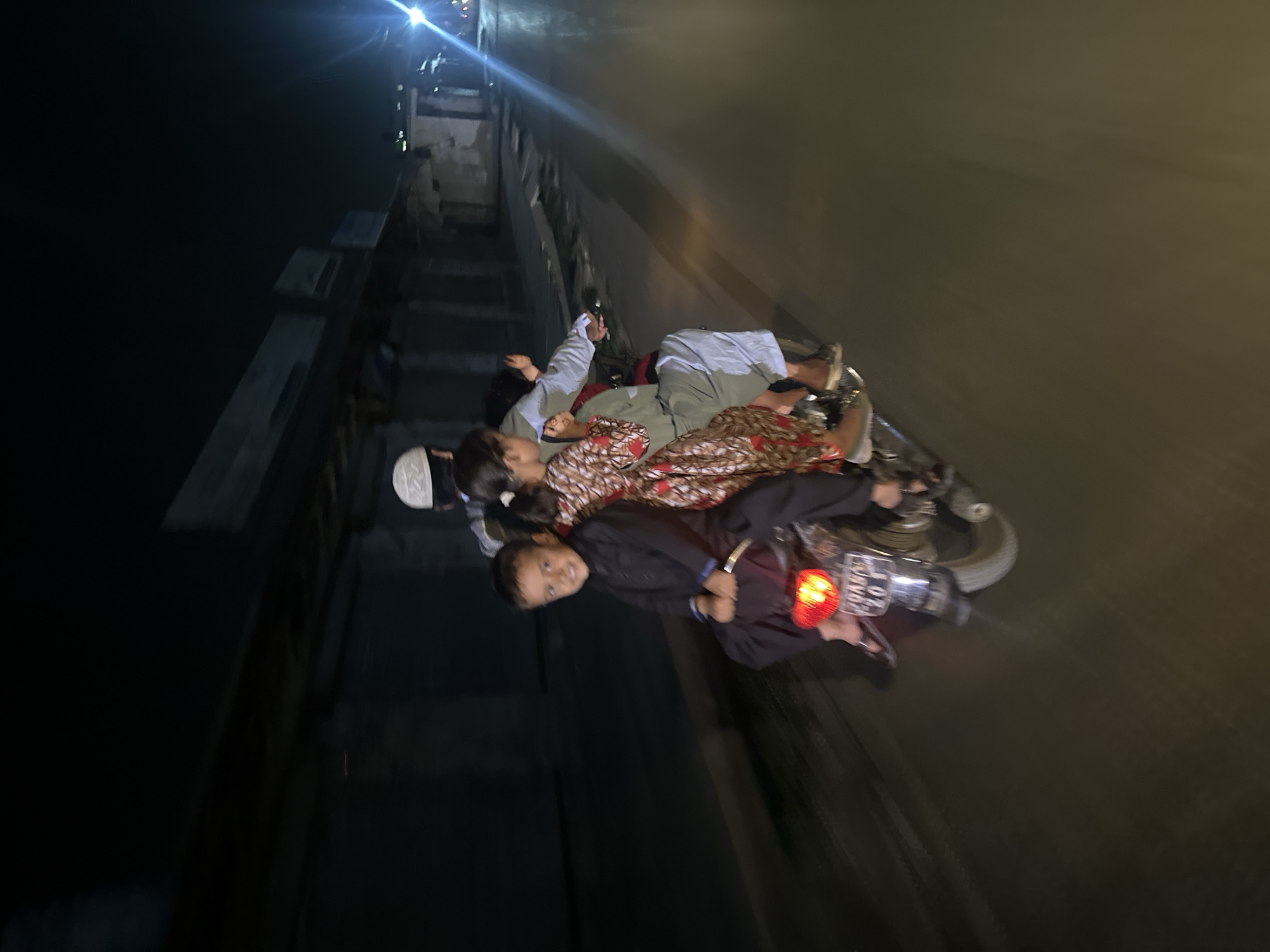 Family rides motorcycle together in Quetta, Pakistan evening