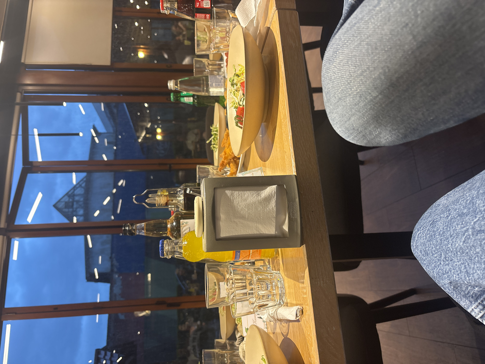 Diner observed at restaurant table wearing blue jeans