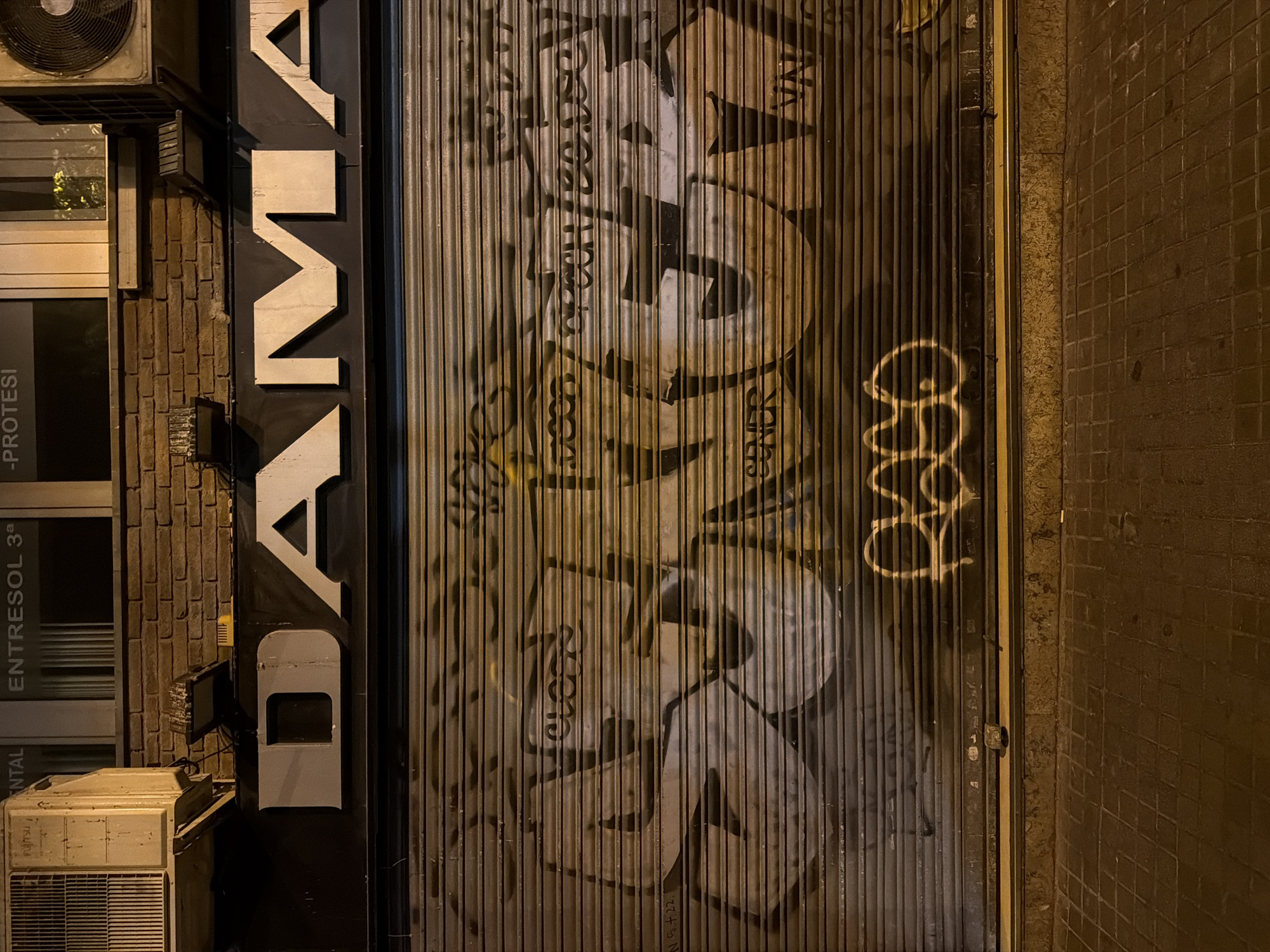 Barcelona's old city at night, monuments lit and most shops shut