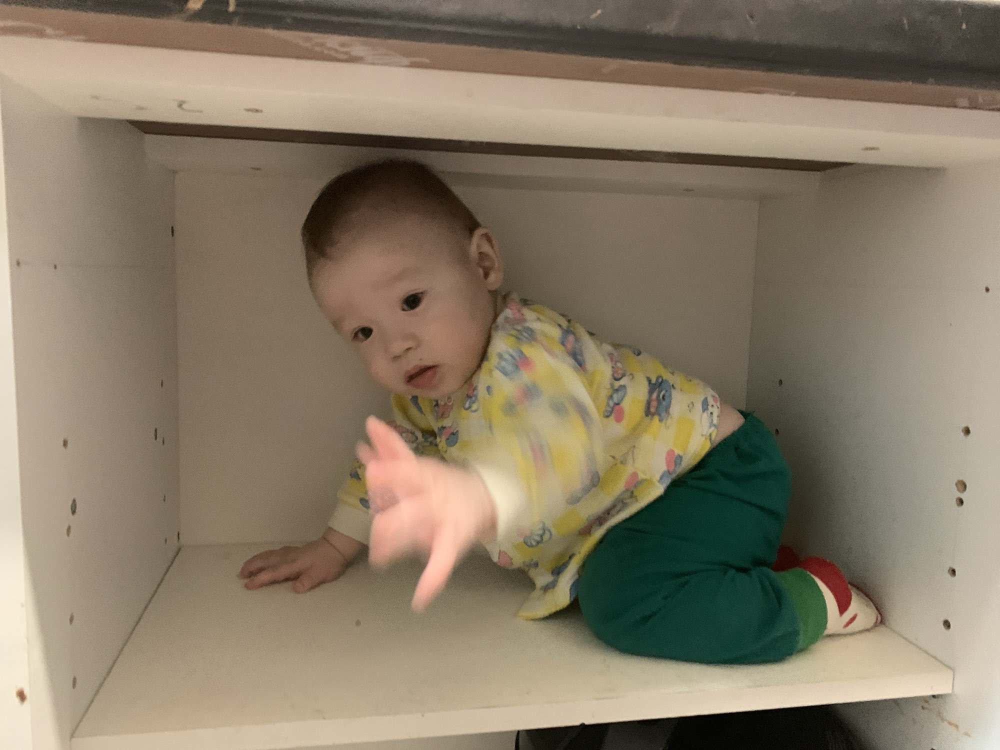 Baby crawls inside white cabinet in Izhevsk home
