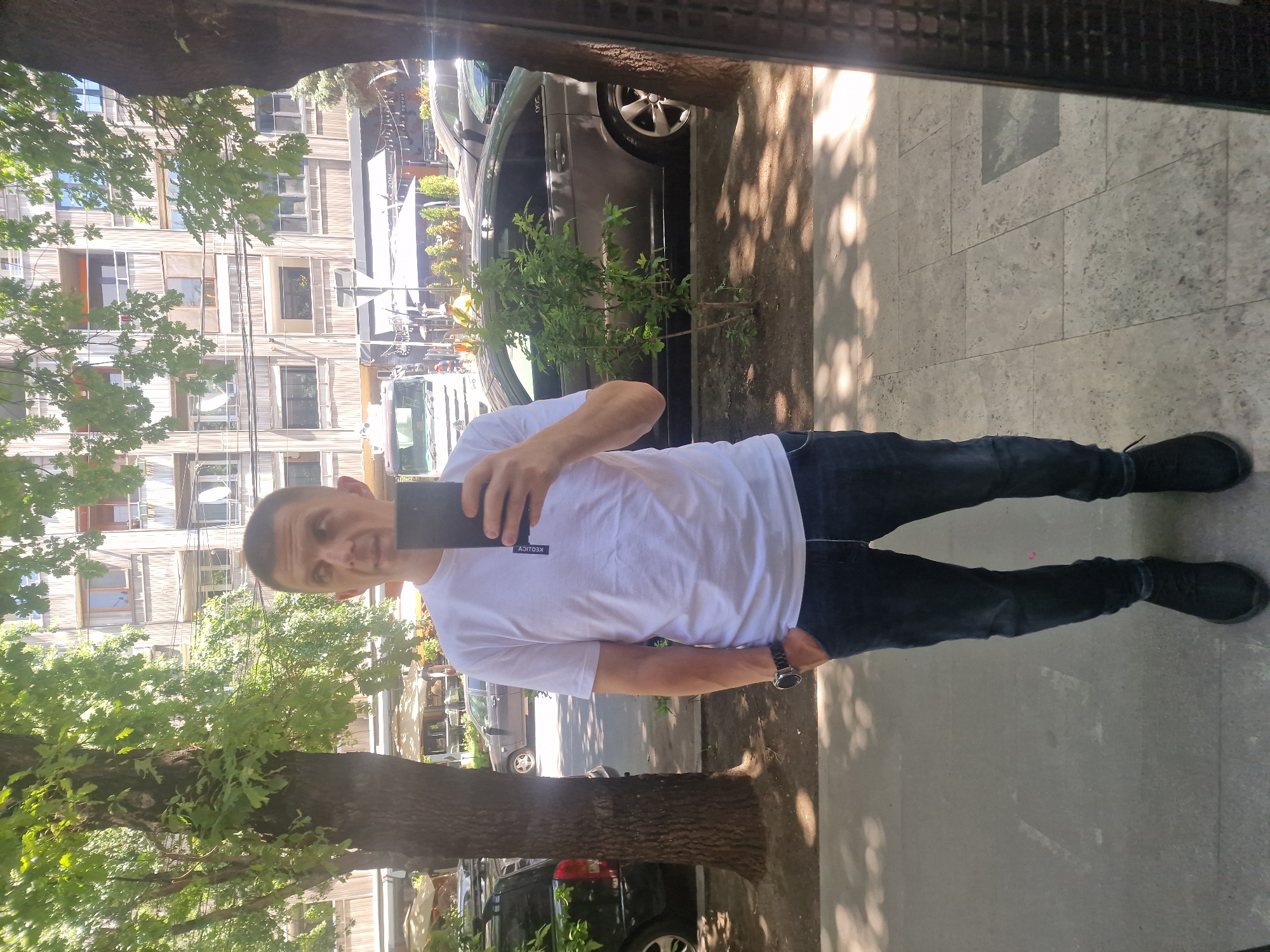 Morning street life in Yerevan, with cars, cafés, and strays