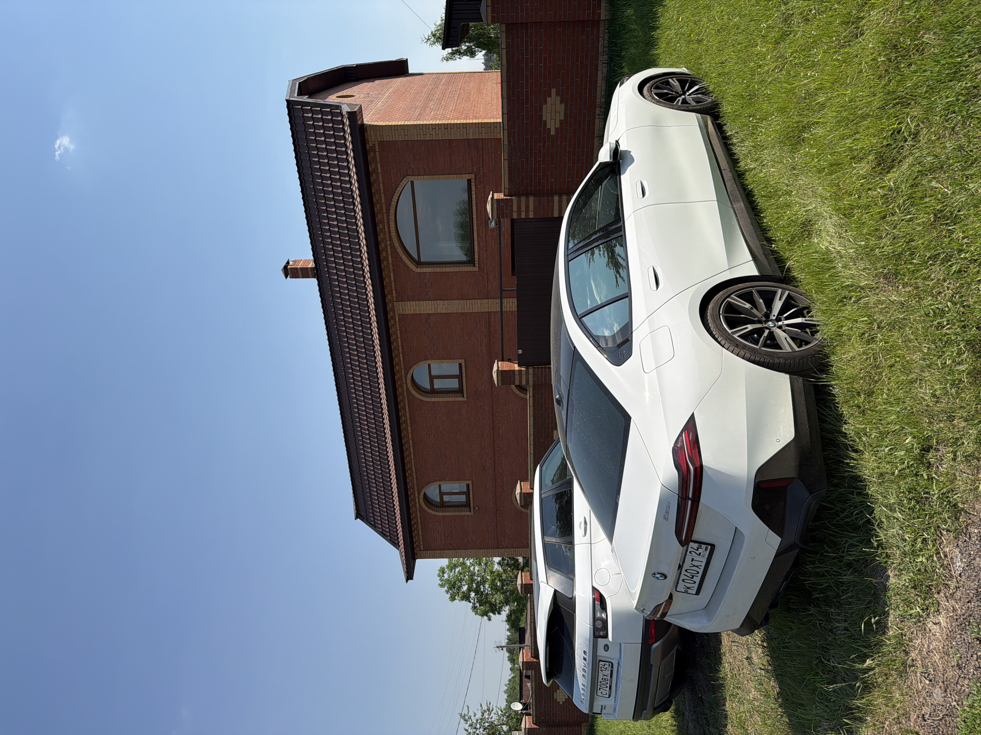 BMW sedan parked in residential Krasnoyarsk on sunny morning