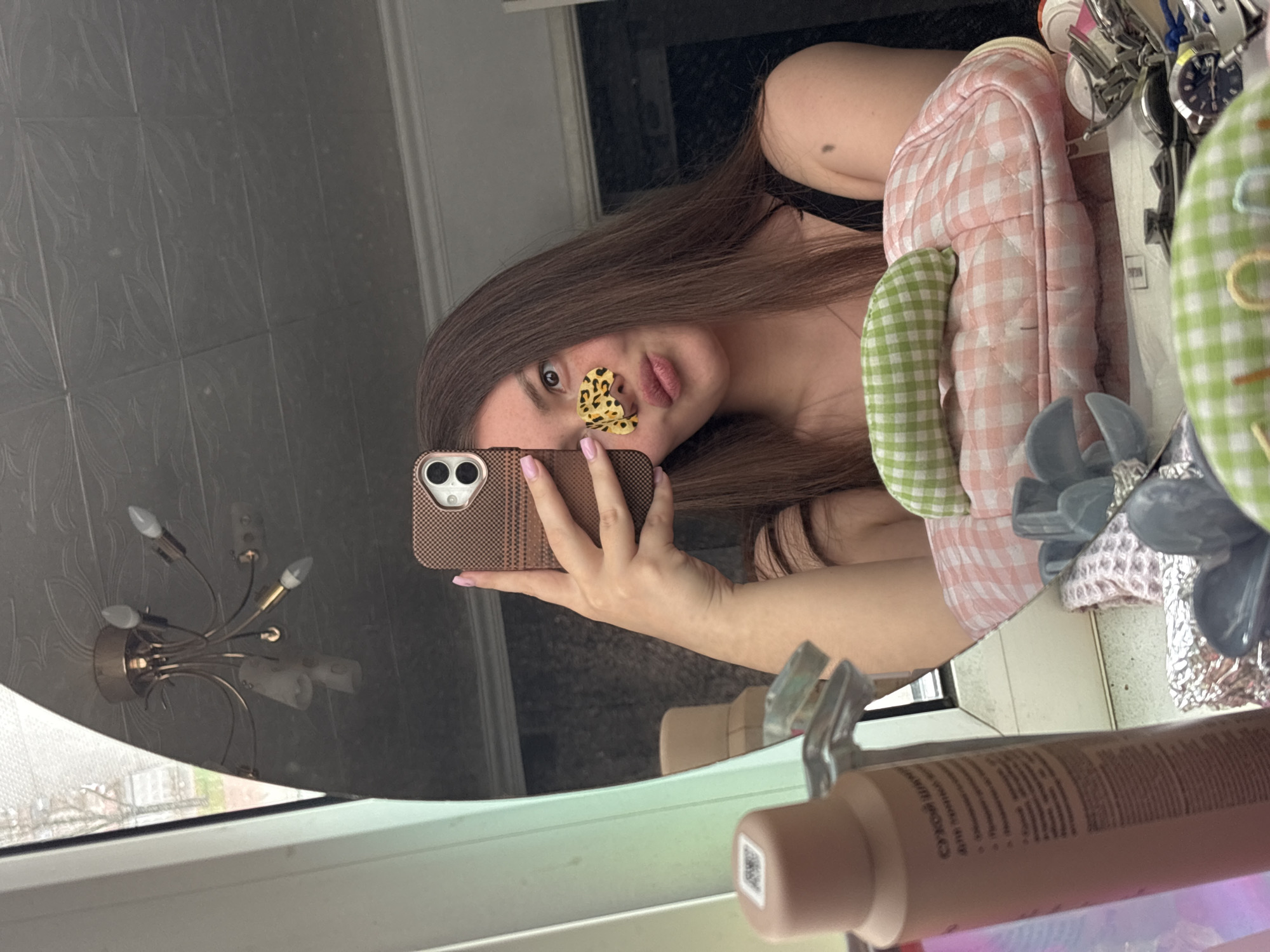 Woman takes mirror selfie with butterfly sticker in Saint Petersburg