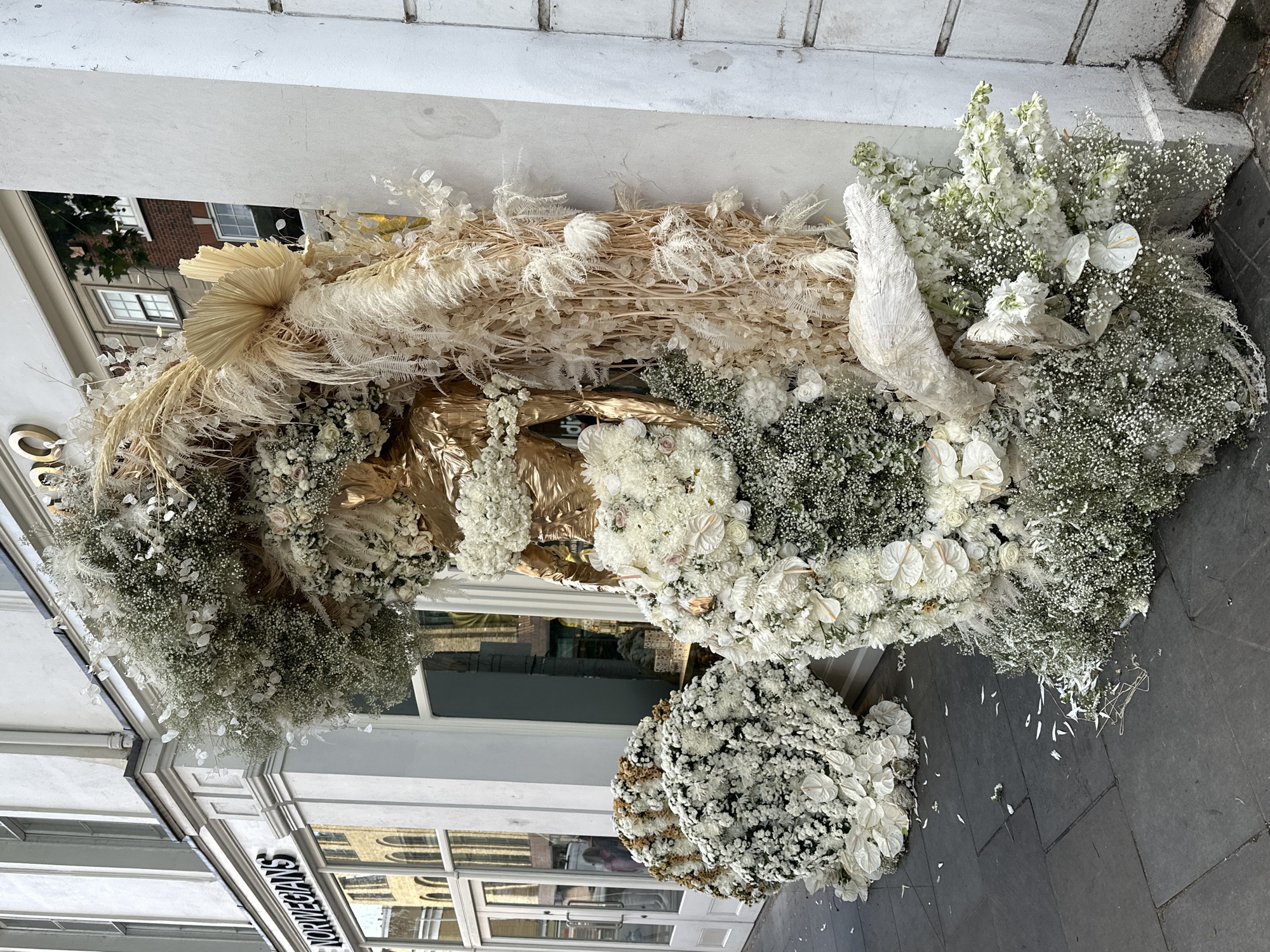 Elaborate floral displays appear outside London storefronts