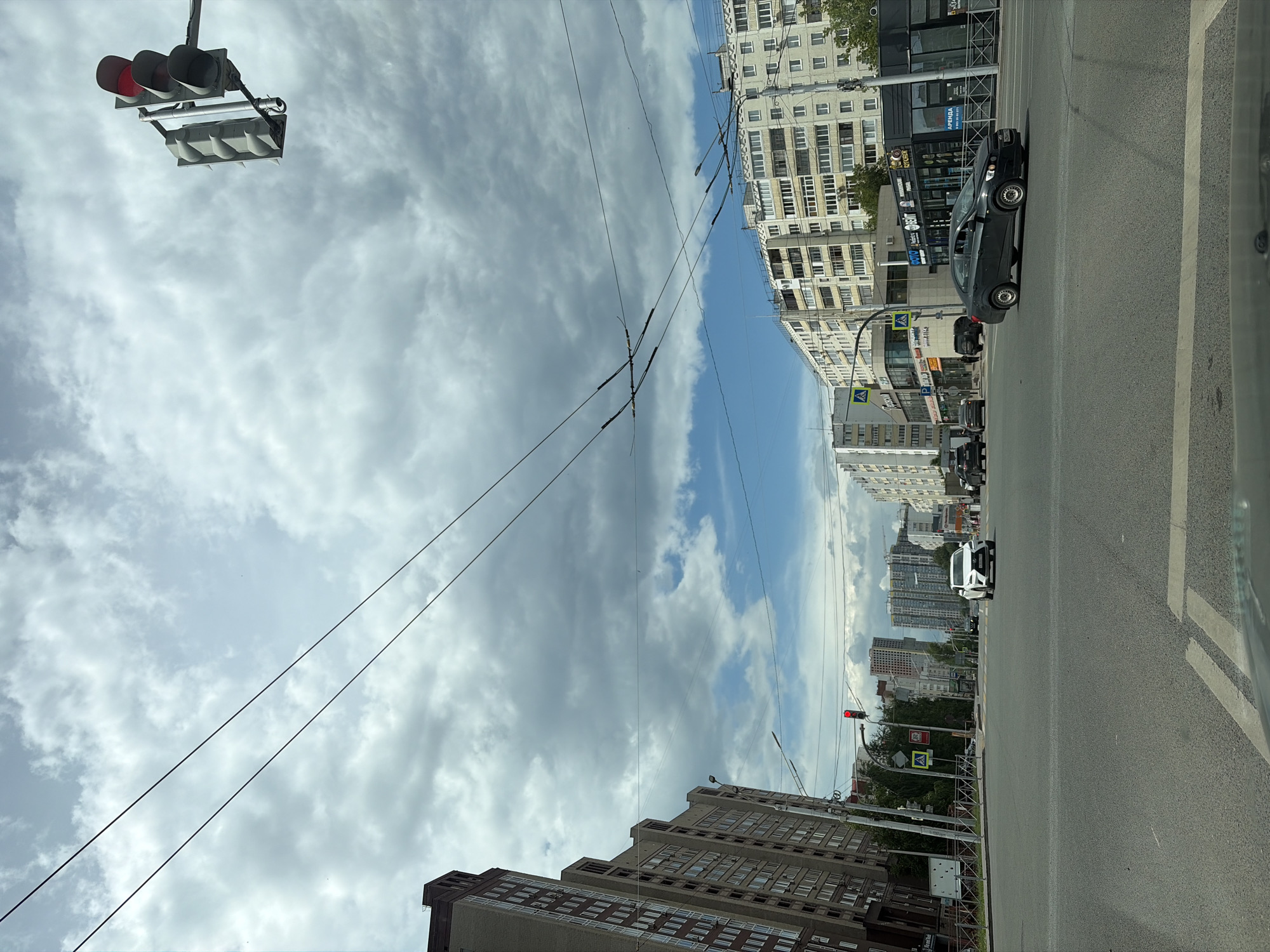 Street-level drive through Ufa under a dramatic summer sky