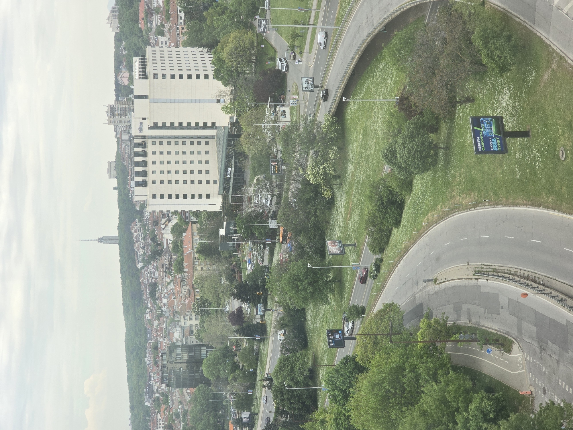 Aerial view captures Sofia cityscape with light highway traffic