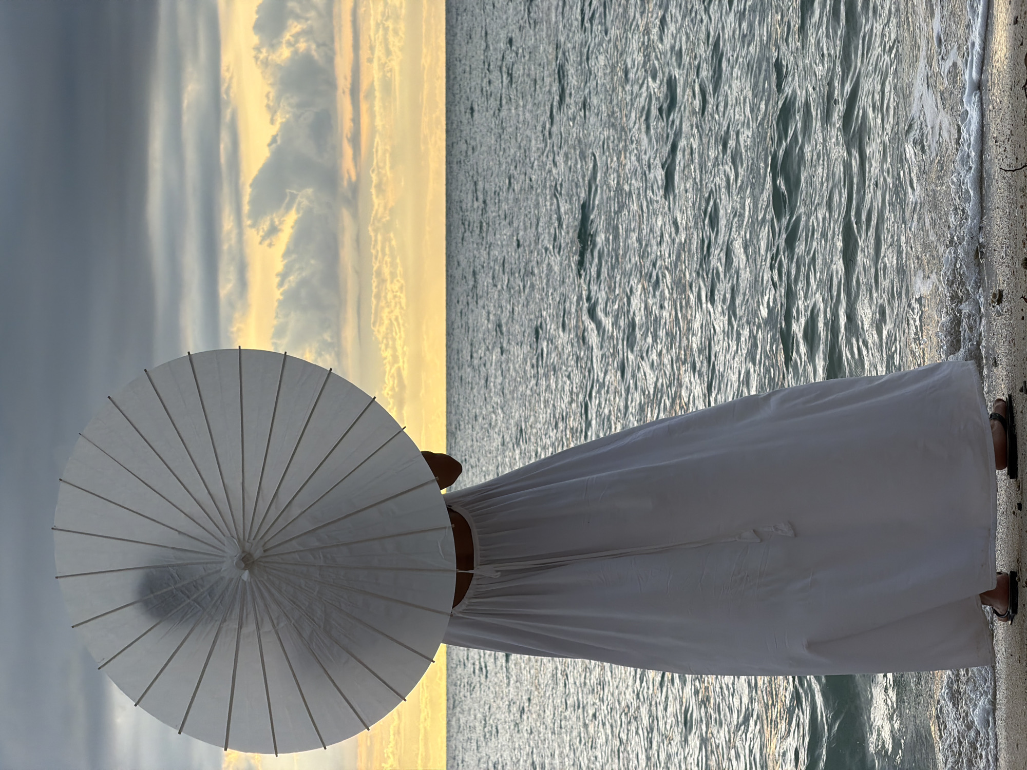 Beached boats and a white parasol on a Koh Samui shore