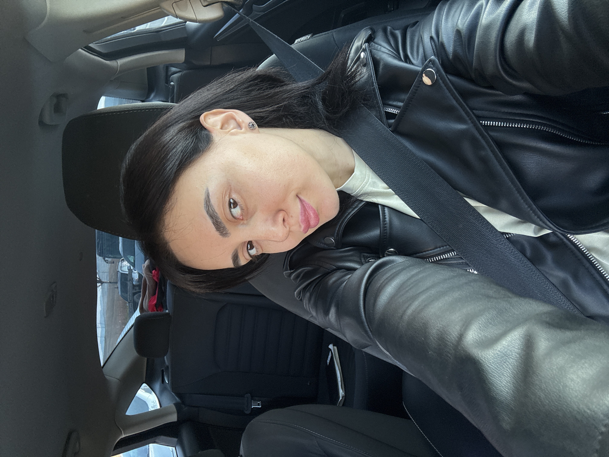 Woman takes selfies in car driver's seat in Tbilisi