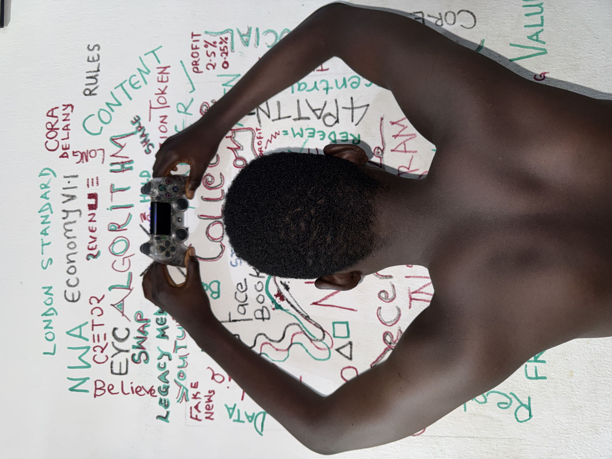 Person photographed drinking water by decorated wall in Ado
