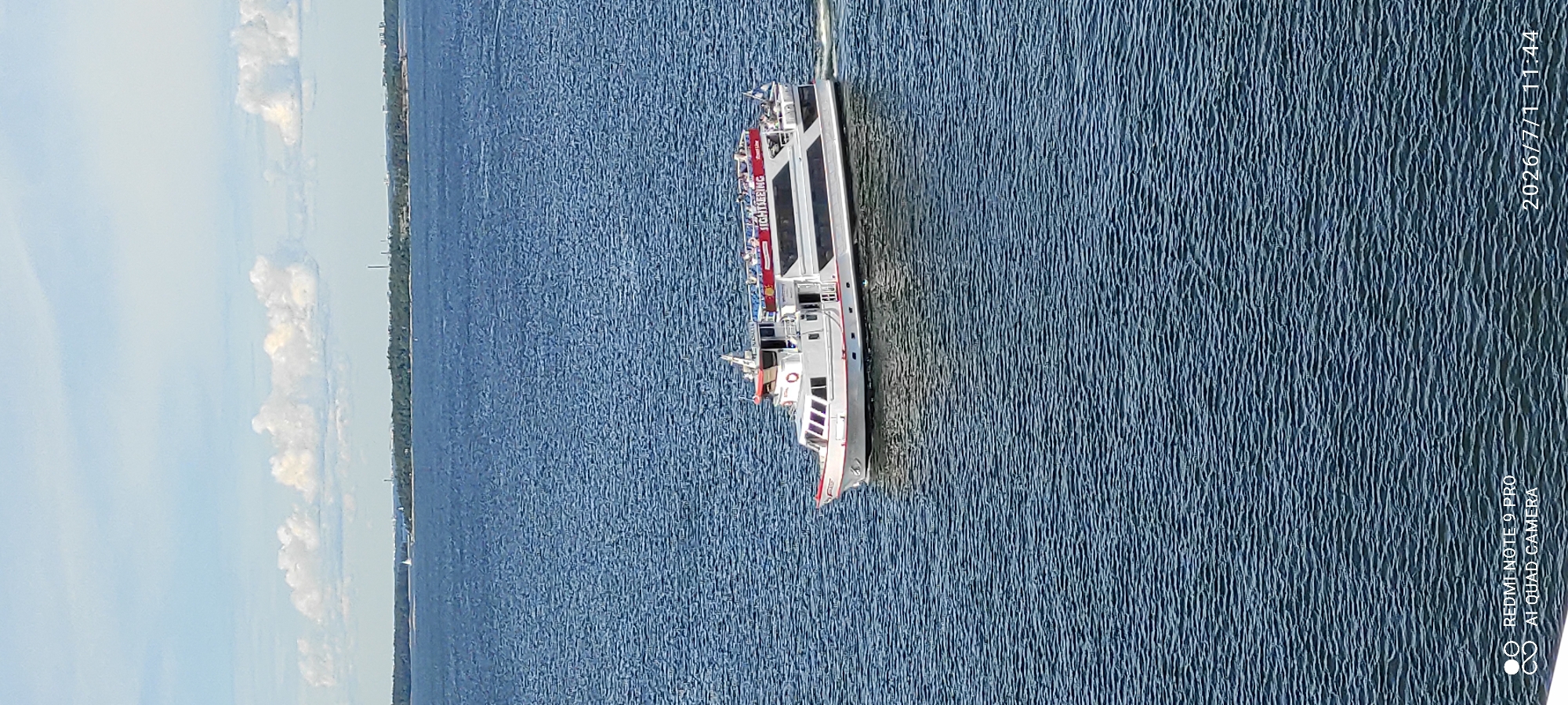 Ferry and sightseeing boat navigate Helsinki's coastal waters