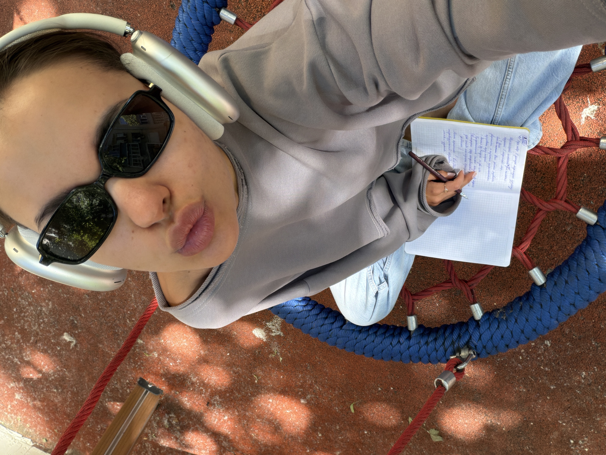 Woman takes playground selfie on net swing in Moscow