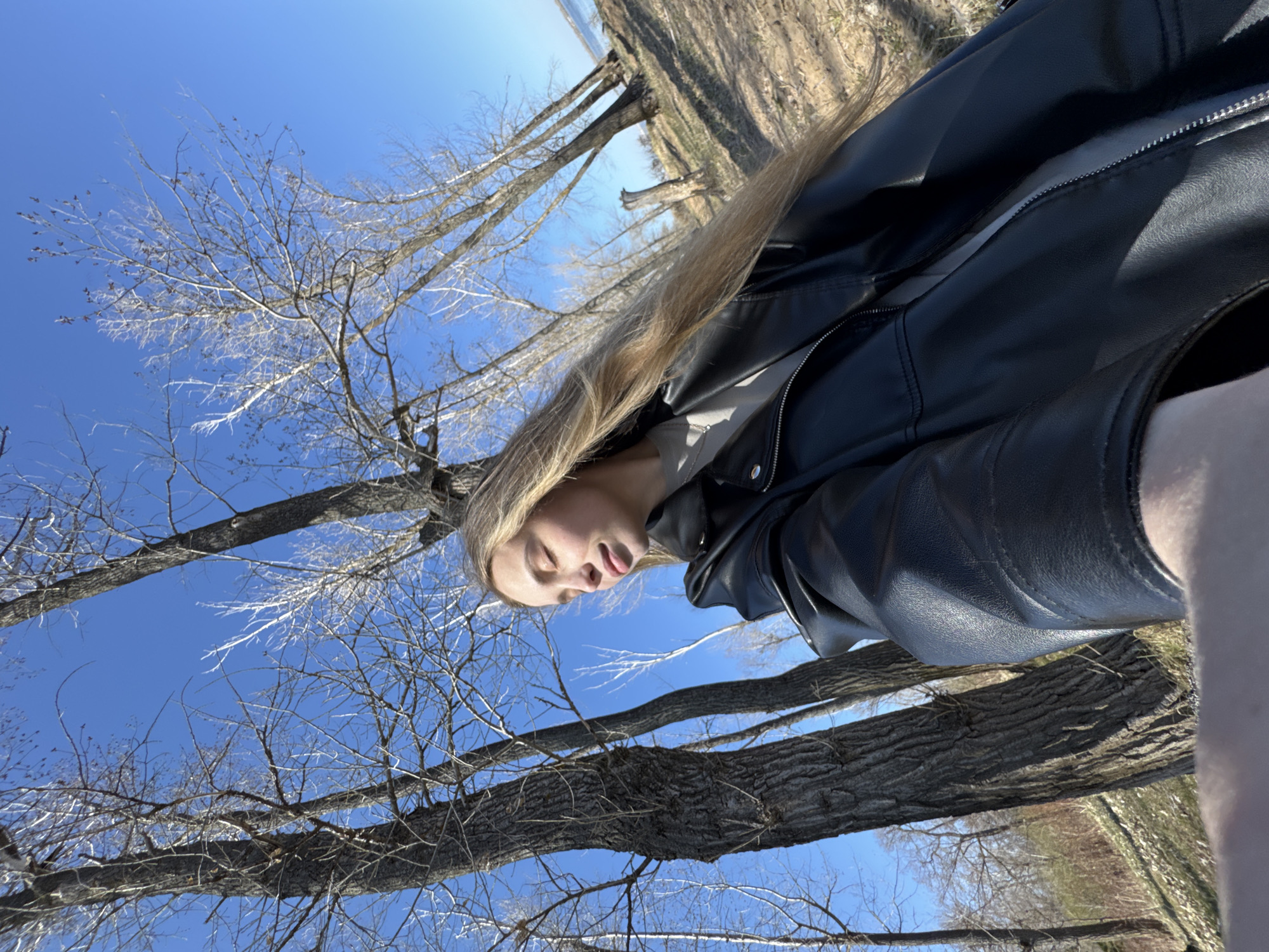 Woman in leather jacket photographed near Russian waterway