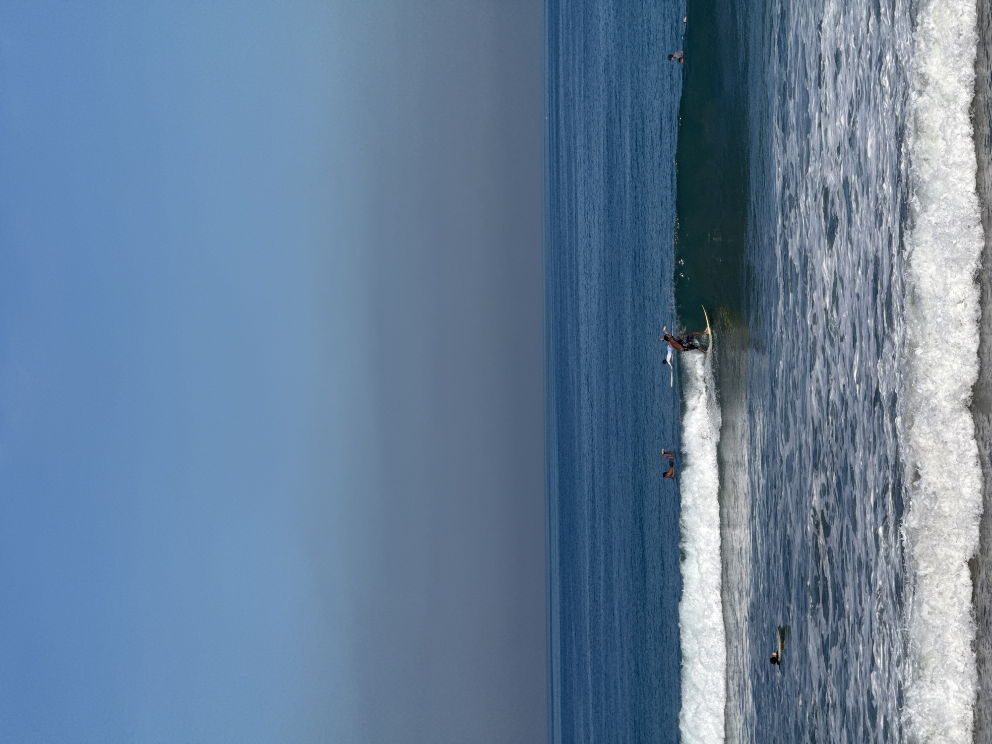 Kuta Beach surf session with street activity nearby
