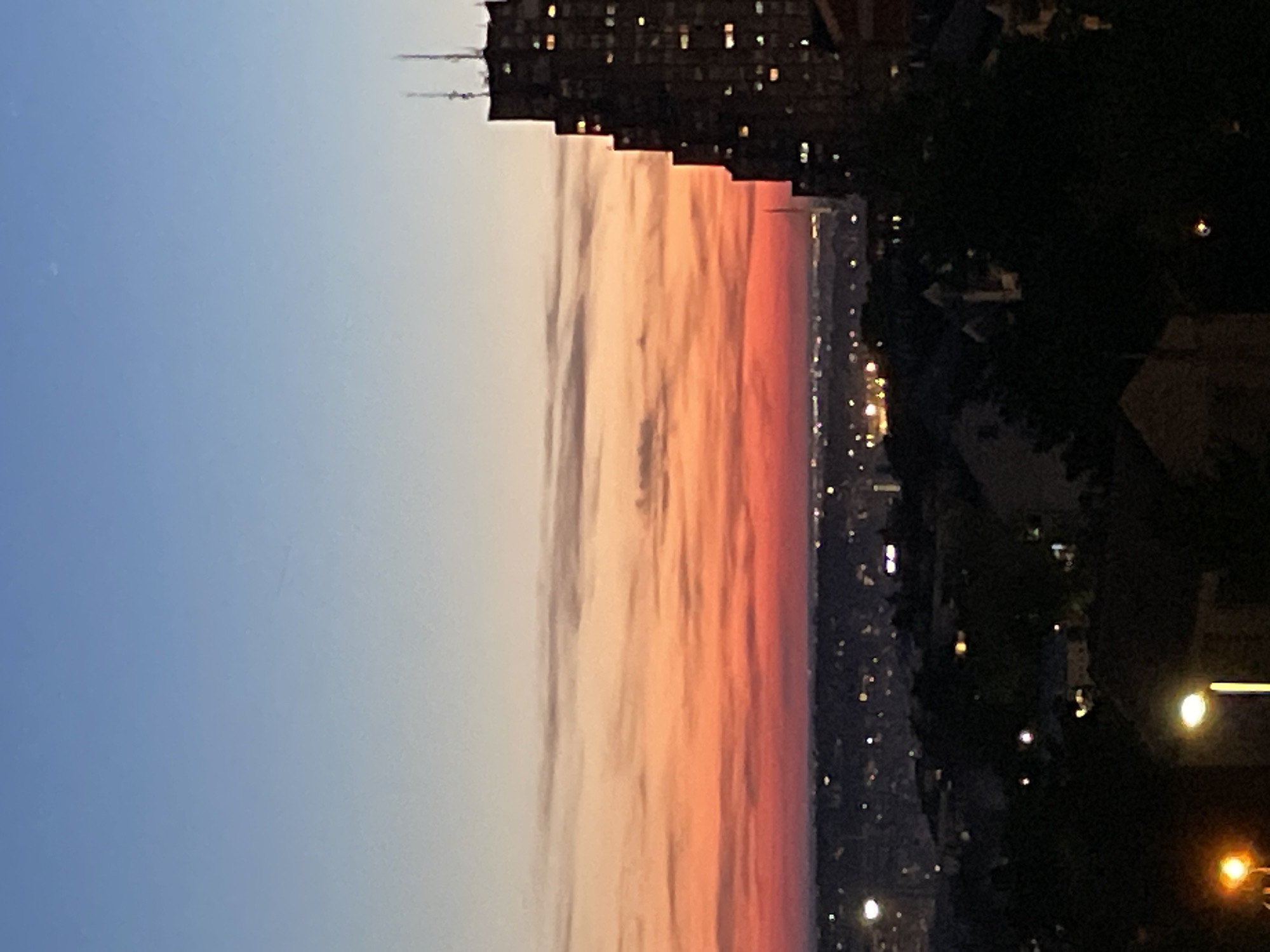 Sunset illuminates construction cranes over Belgrade cityscape