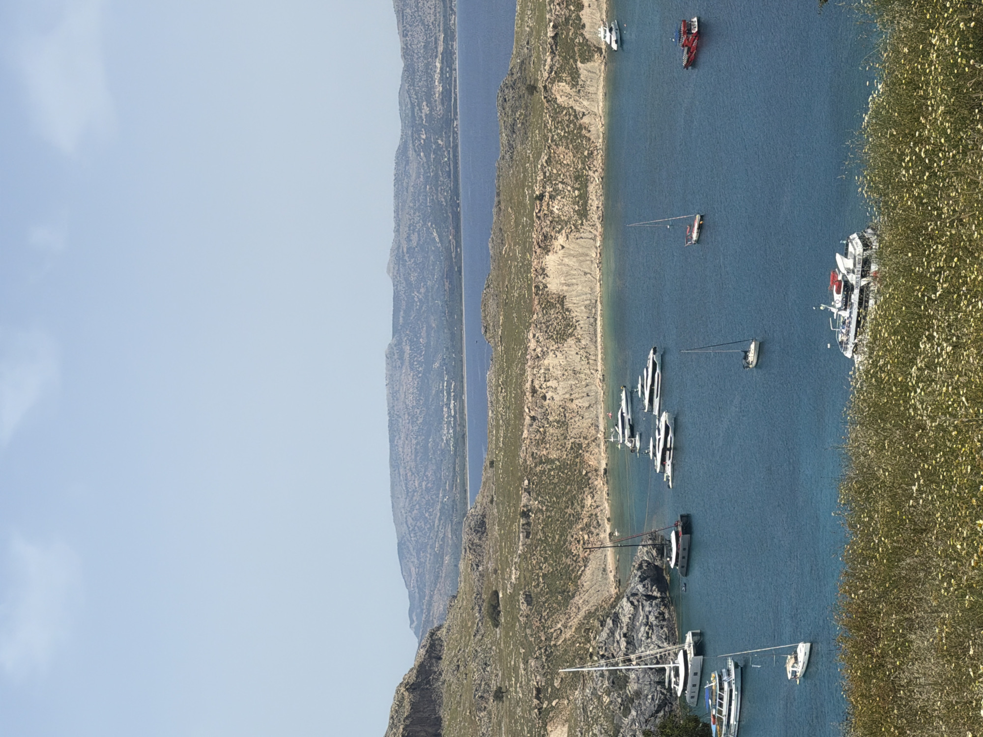 Boats anchored in Lindos bay under clear skies