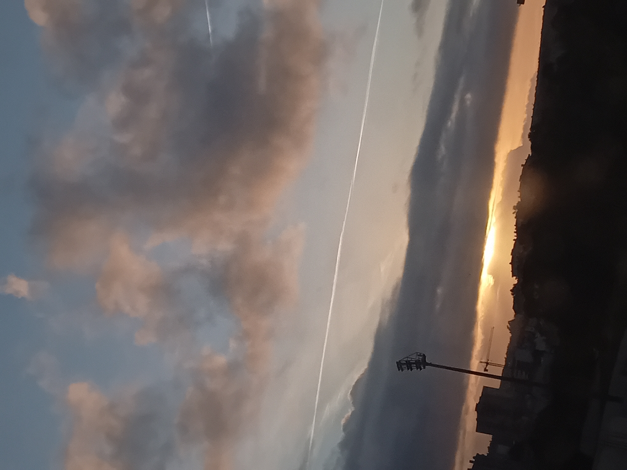 Urban dawn captured from elevated position, dramatic skies observed