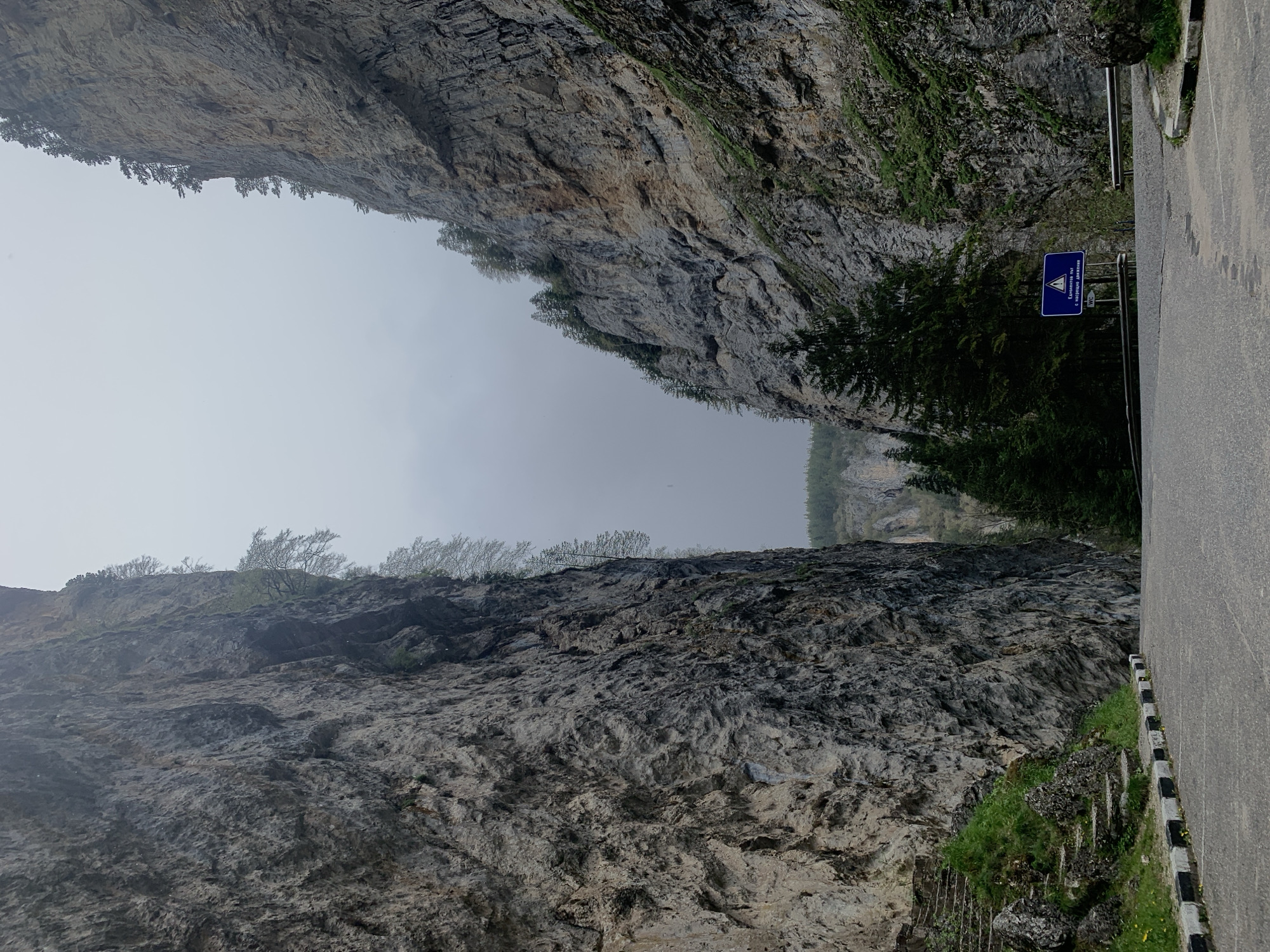 Mountain road with rocky cliffs documented by witness