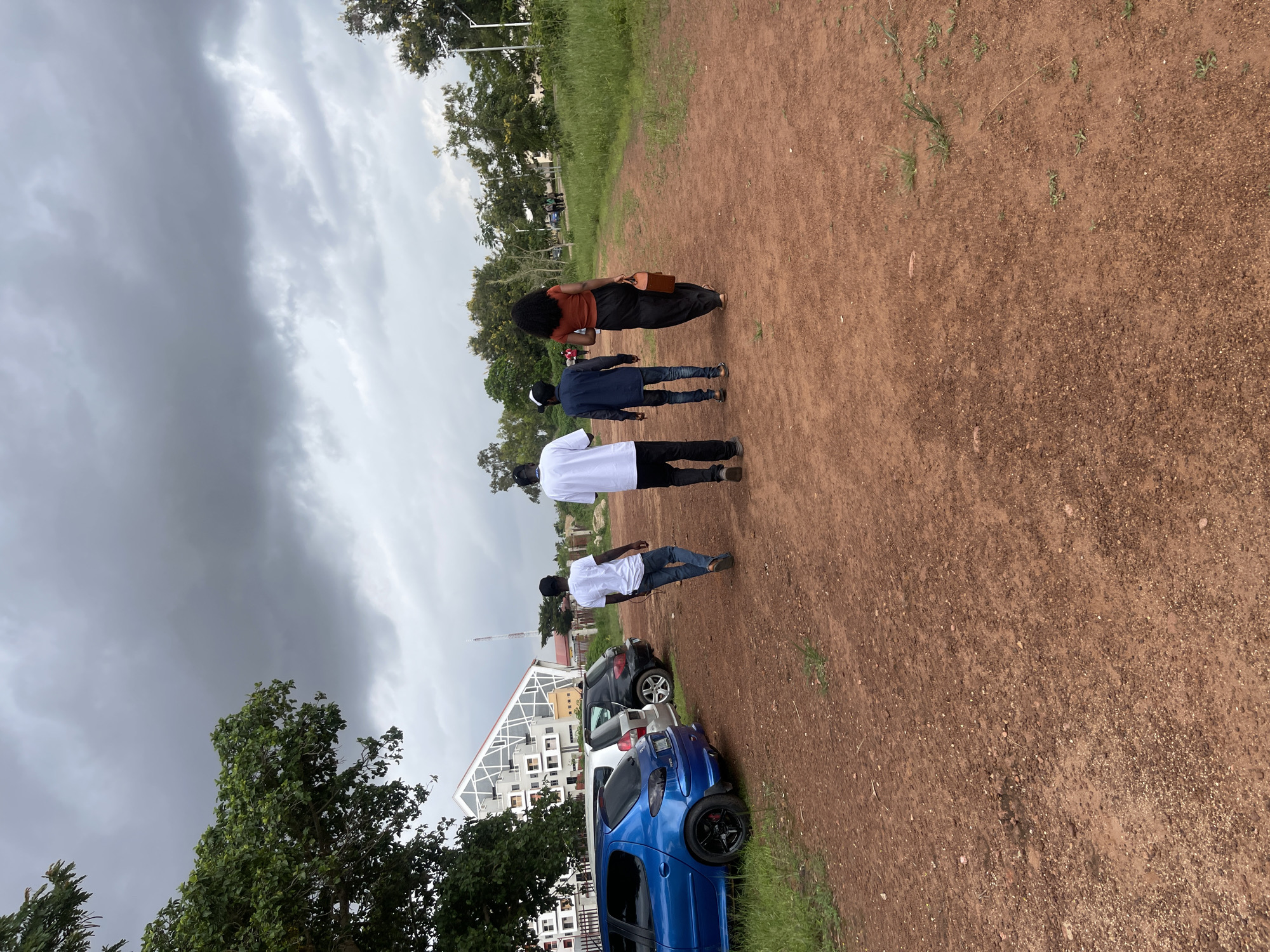 Overcast afternoon across farms, paths, and a river in central Nigeria