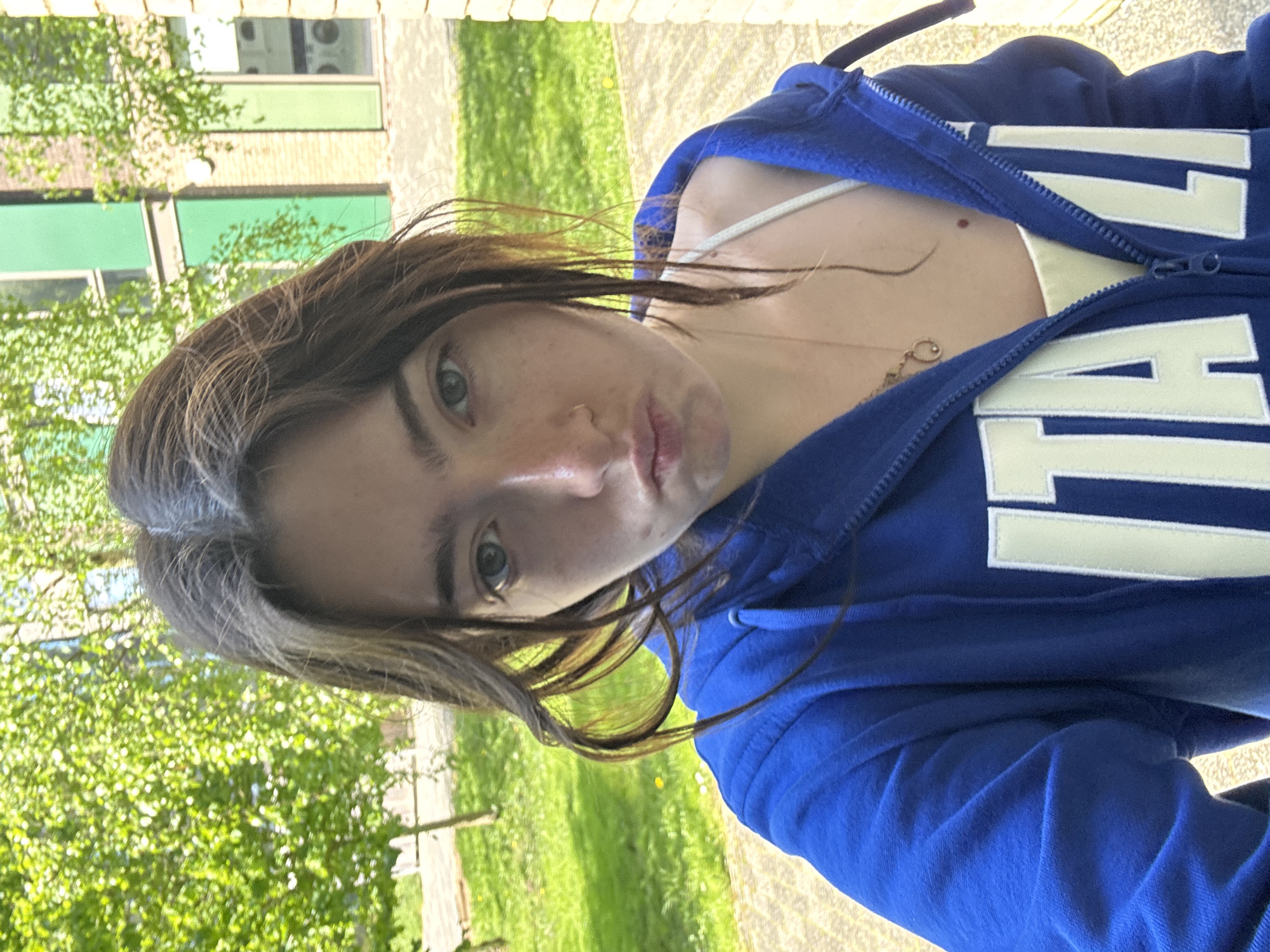Woman takes selfies while moving through Hull city locations
