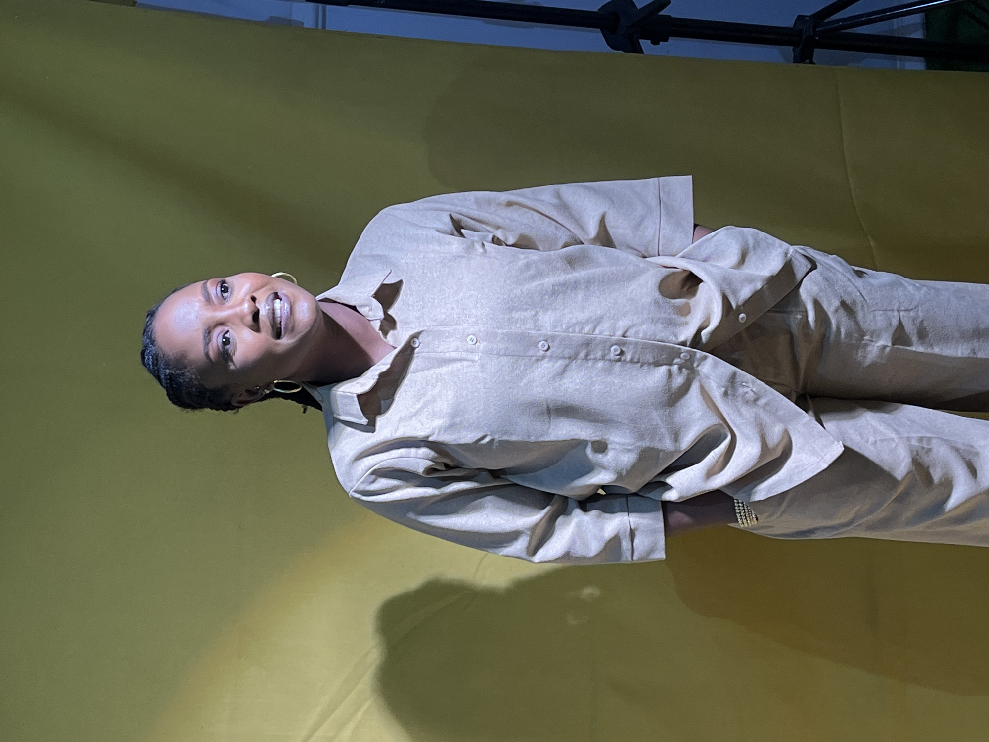 Studio portrait session against a gold backdrop in Nigeria